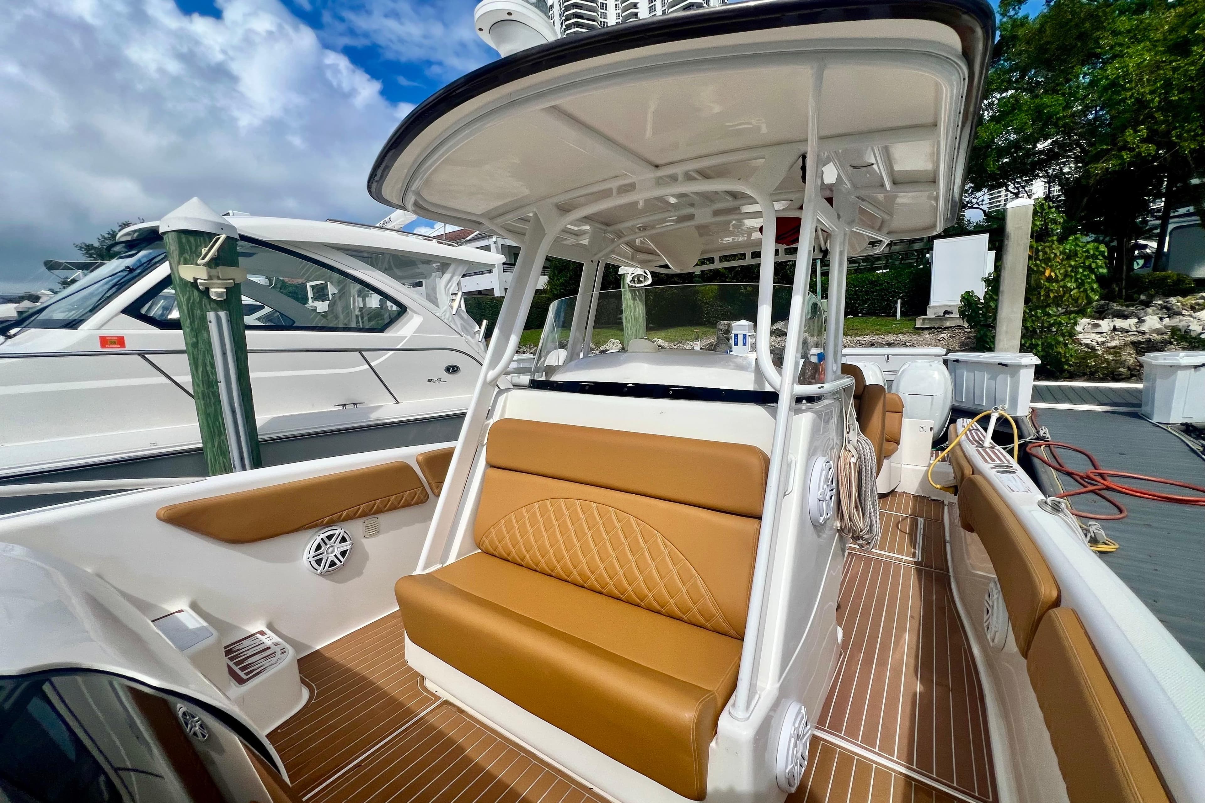 2011 Deep Impact 36 Open boat with tan seating and sleek design at dock.