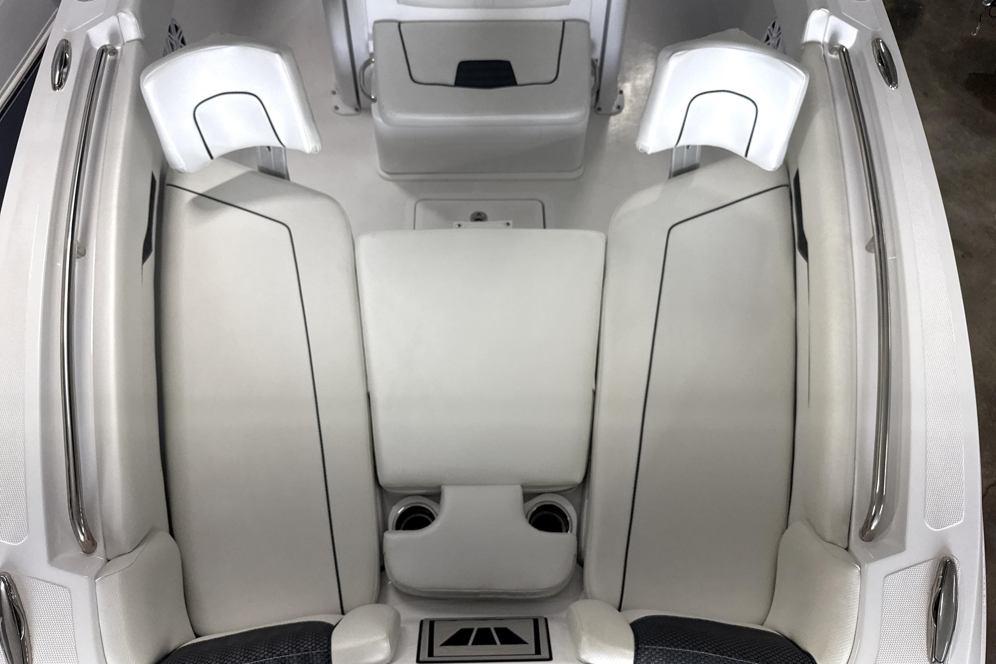2025 Wellcraft 223 Fisherman boat interior with white cushioned seating and stainless steel railings.