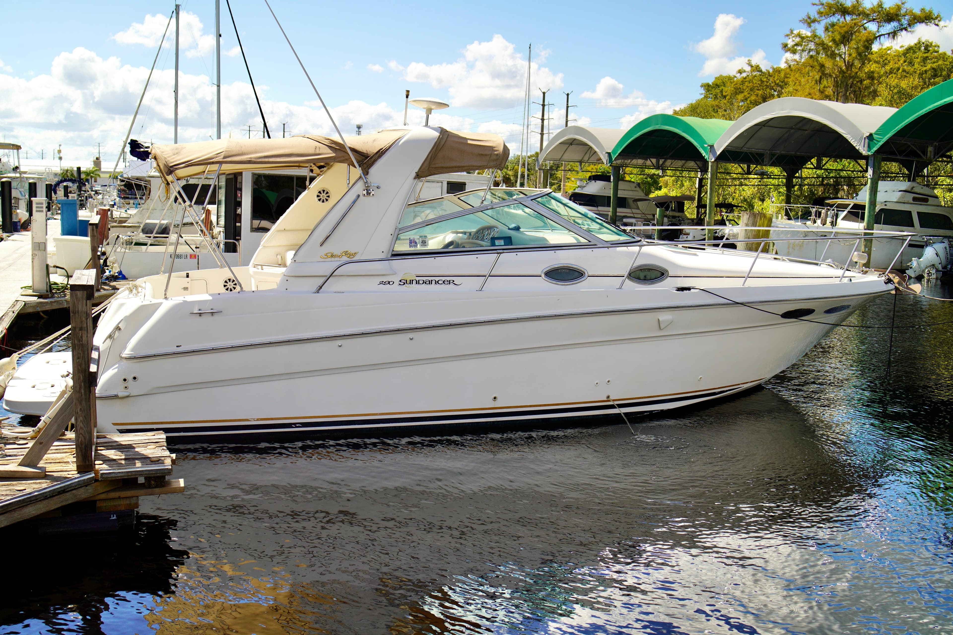 2000 Sea Ray 280 Sundancer docked at marina under sunny skies.