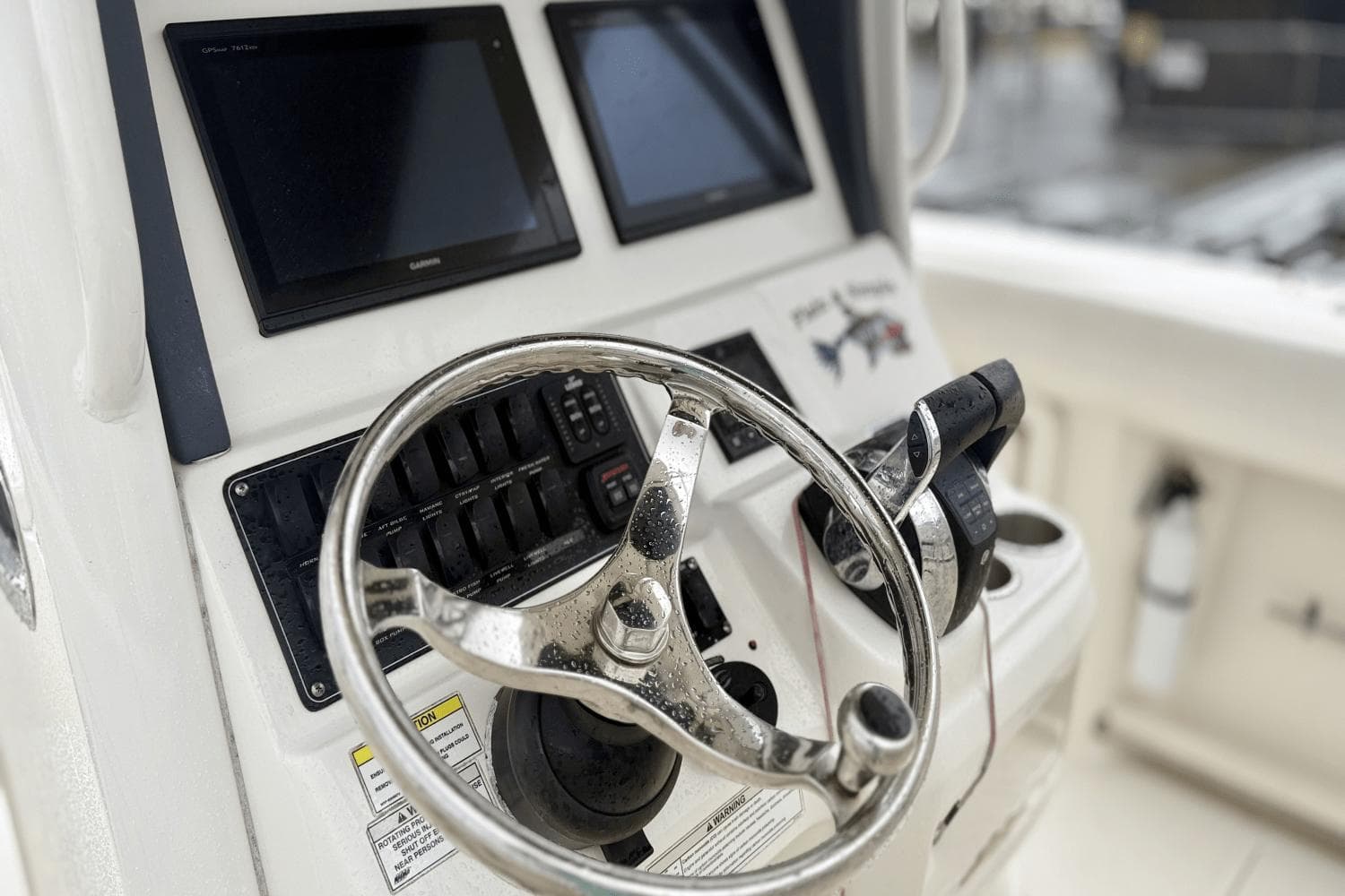 2015 Boston Whaler 280 Outrage helm with steering wheel and navigation screens.