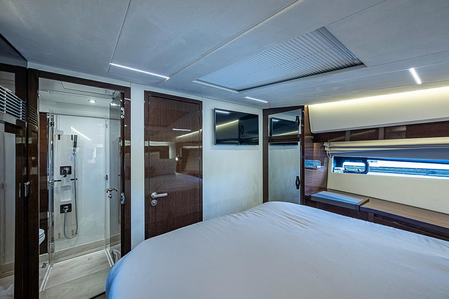 Luxurious interior of 2021 Prestige 520 yacht with modern bedroom and ensuite bathroom.