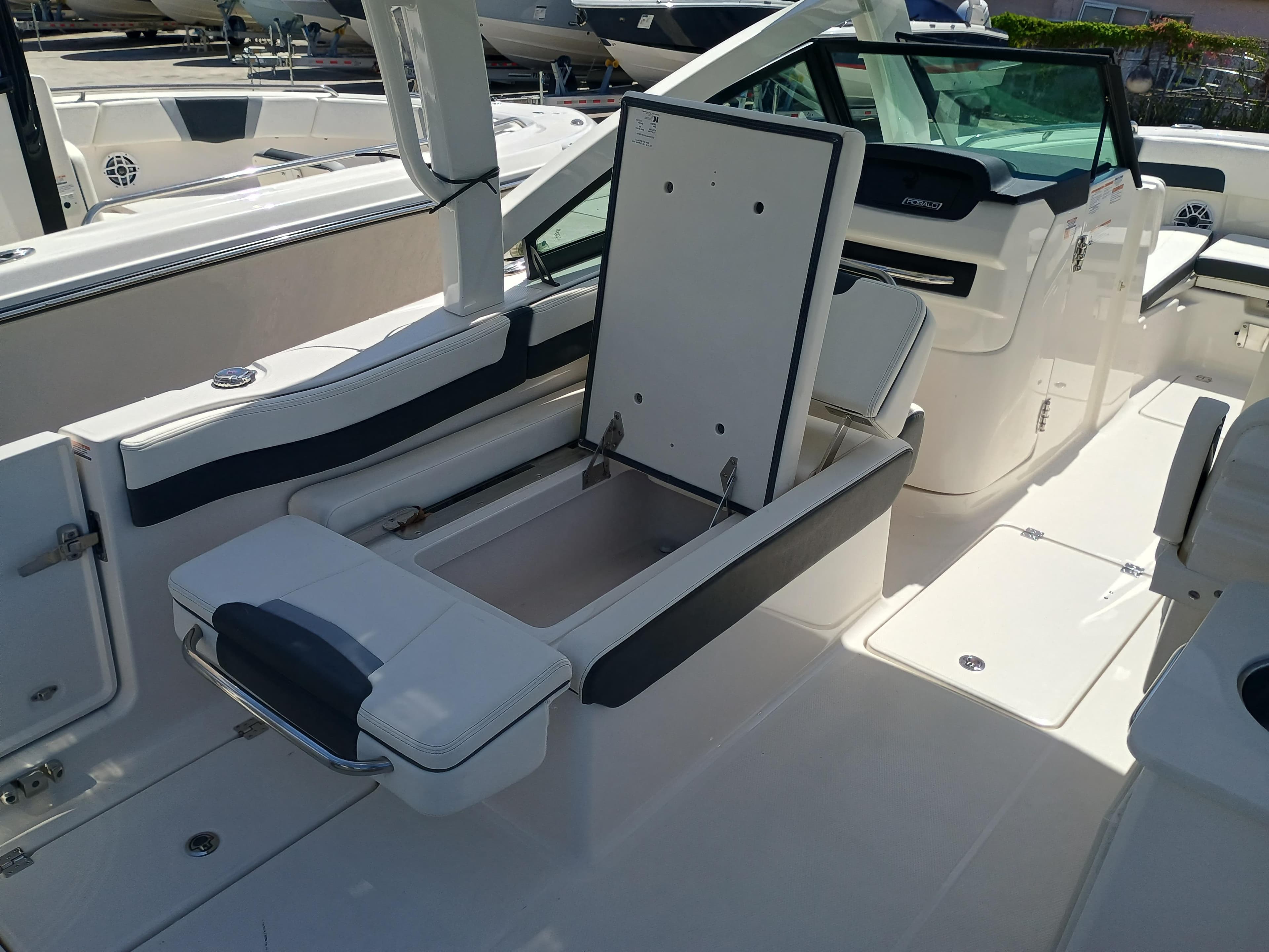 2025 Robalo R257 Dual Console boat interior with open storage compartment.