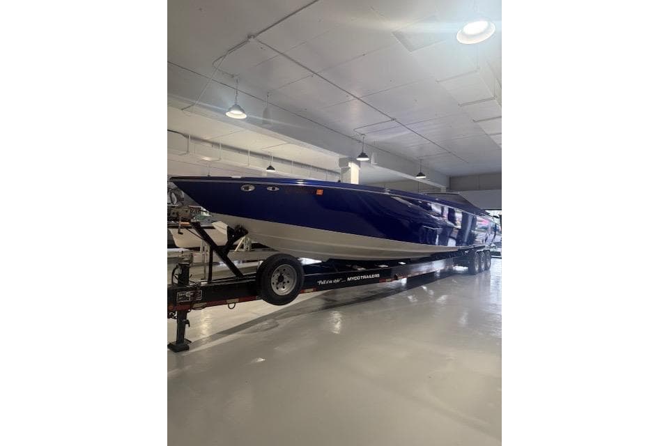 2007 Nor-Tech 5000V boat in a showroom, displayed on a trailer.