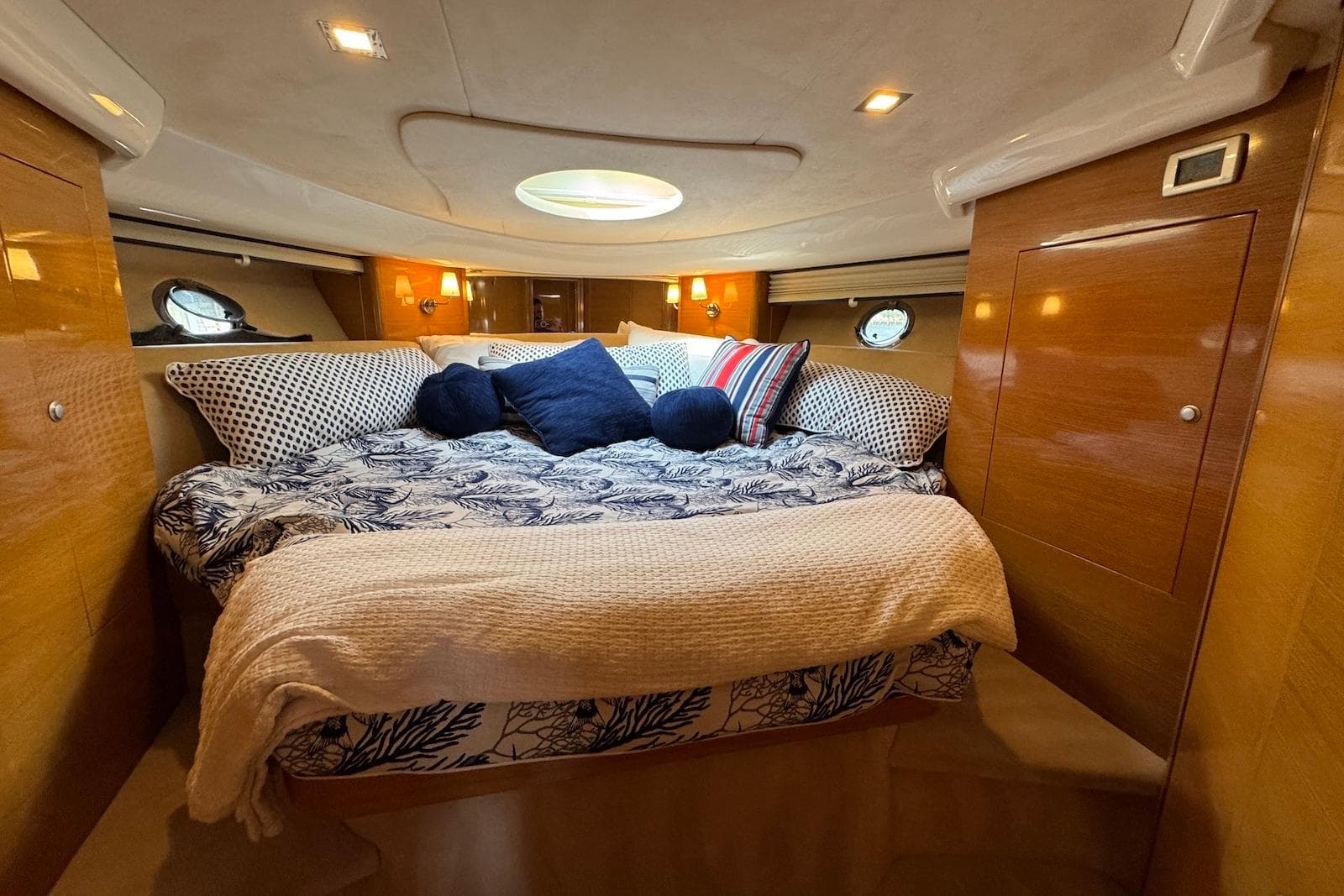 Luxurious cabin interior of 2009 Cranchi Mediterranee 43 yacht with cozy bedding.
