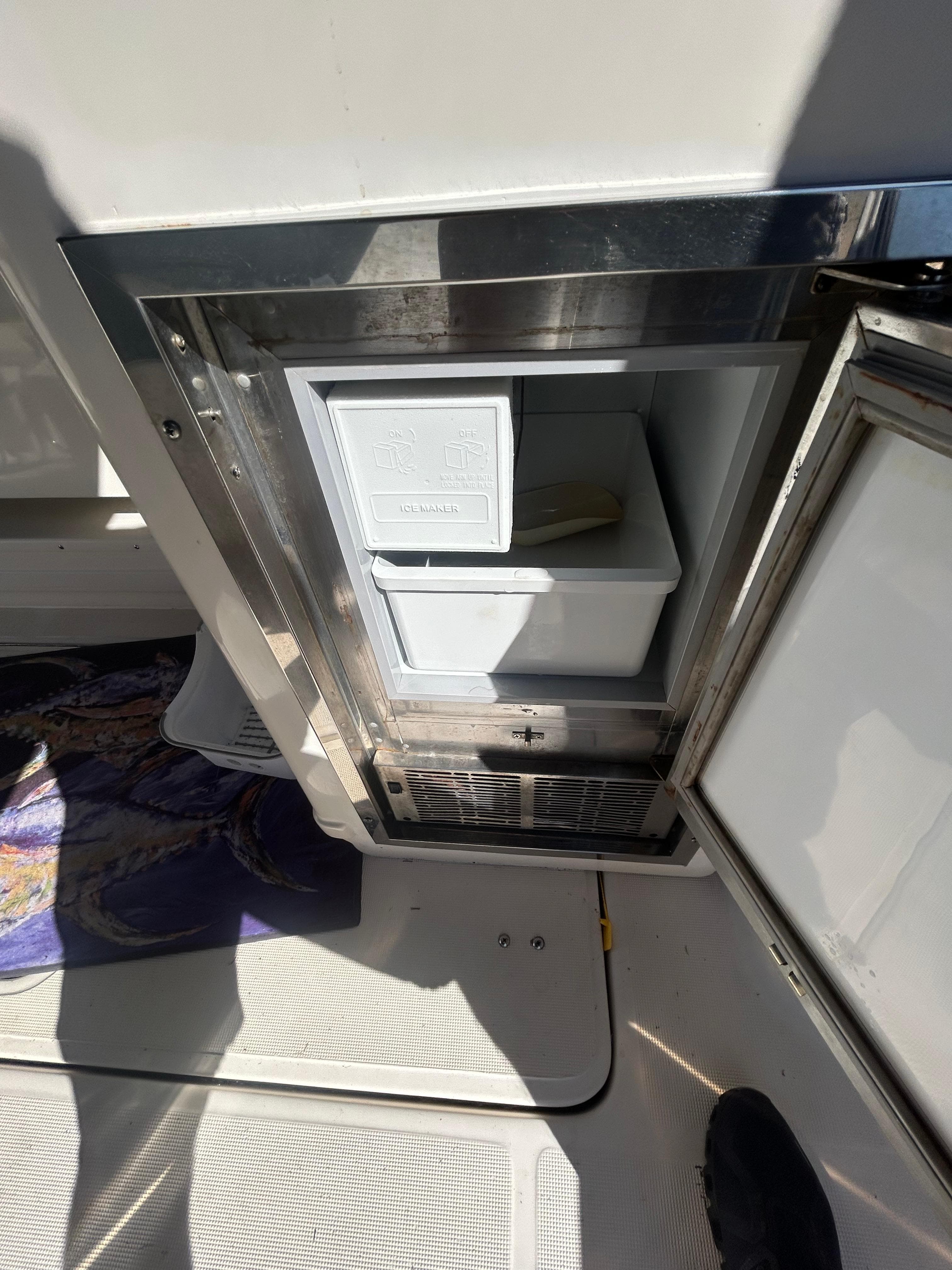 1998 Tiara Yachts 3500 Express, open mini fridge on deck, stainless steel finish.
