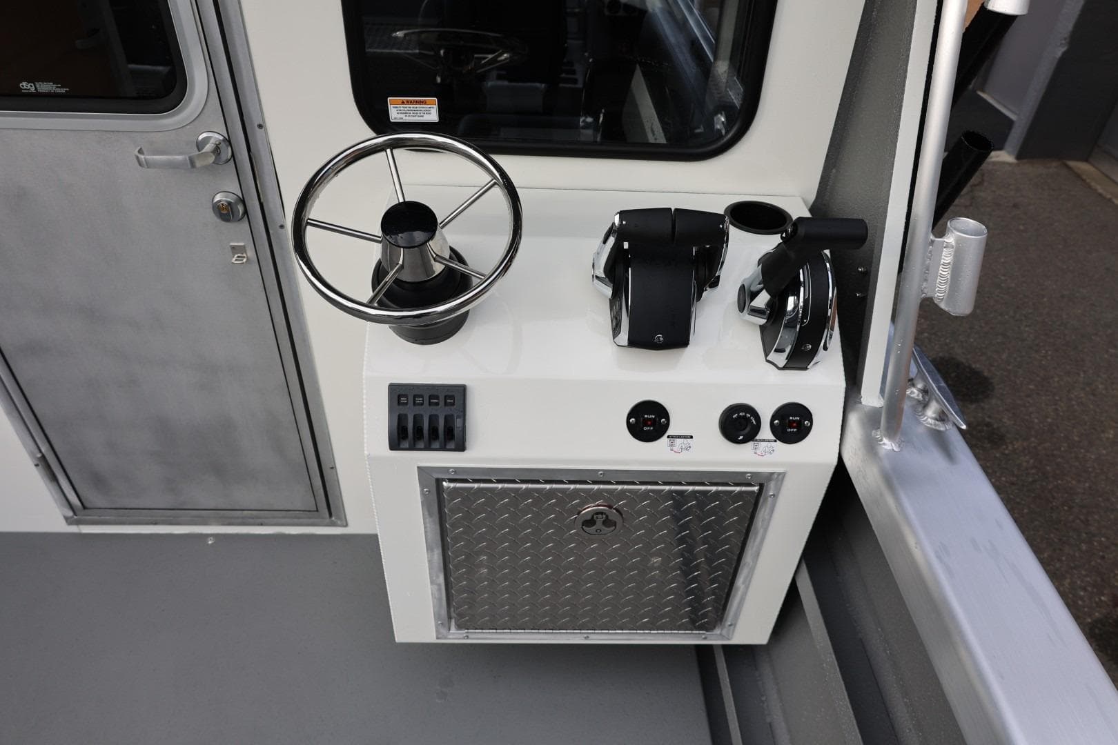 Control panel of 2026 Thunder Jet 26 Alexis Pro XL boat, featuring steering wheel and throttle controls.