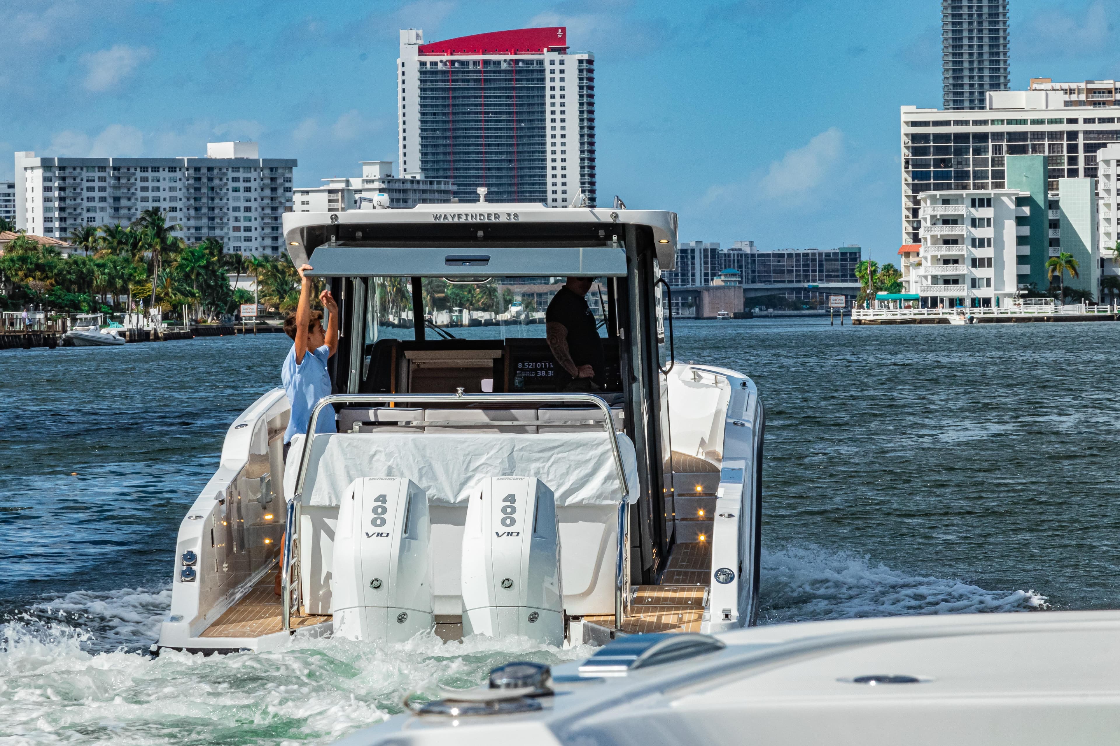 Aiata Wayfinder 38 Cabin 2026 on water with city buildings.