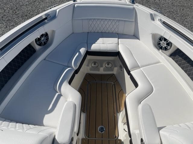 2022 Sea Ray SLX 280 boat interior with white seating and wood flooring.