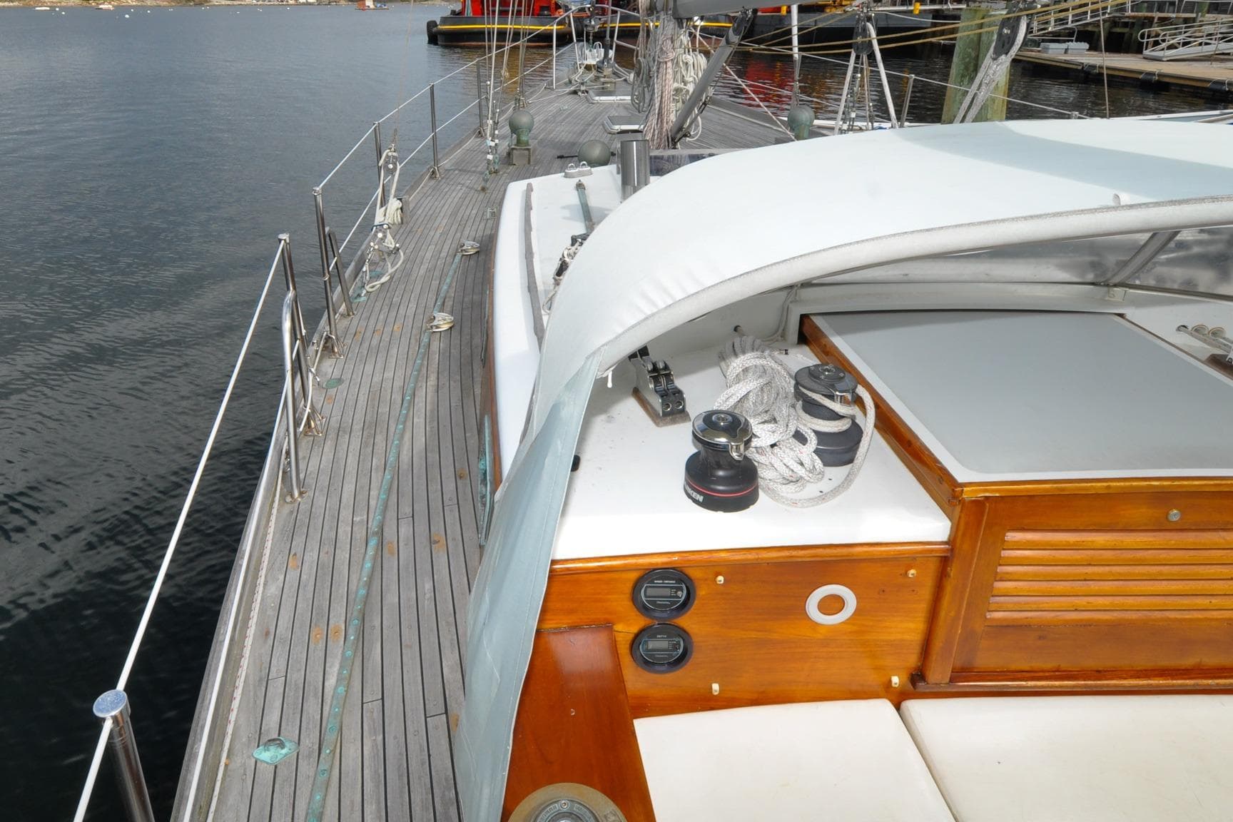 1987 Custom Wittholtz/Luzier Sloop/Cutter deck with winches and ropes, docked by calm water.