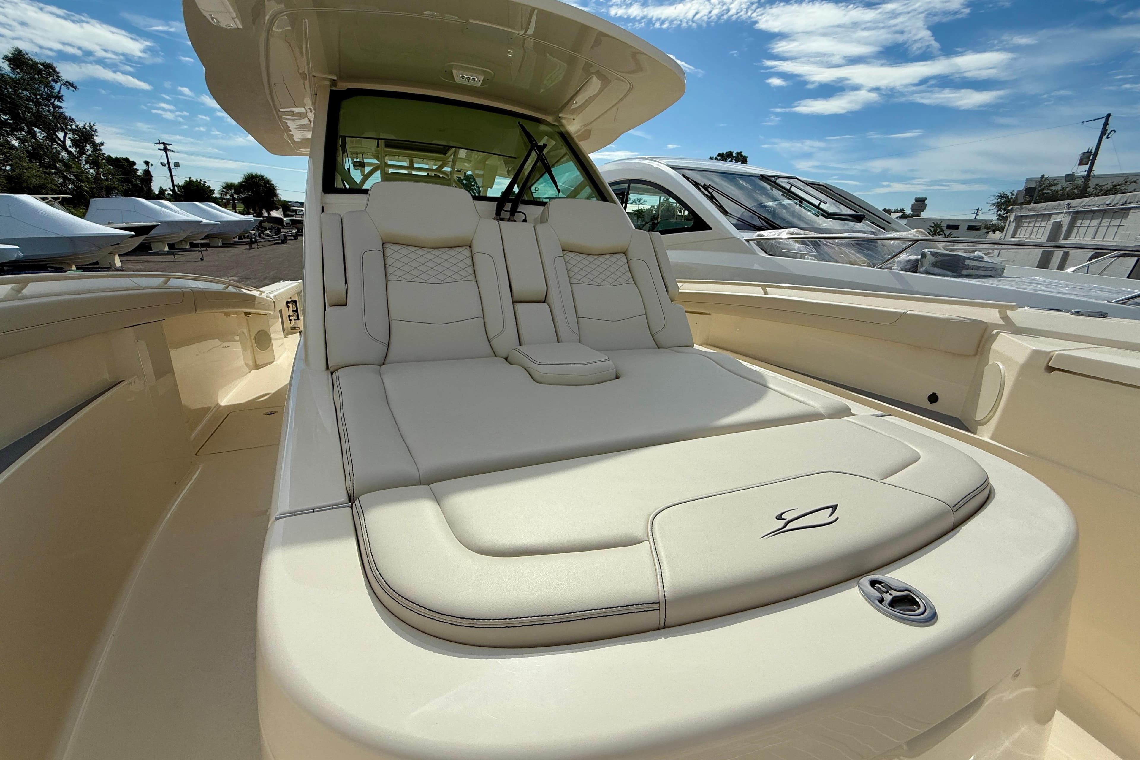 Luxurious seating on 2026 Scout 400 LXF Li-Ion boat under clear blue sky.