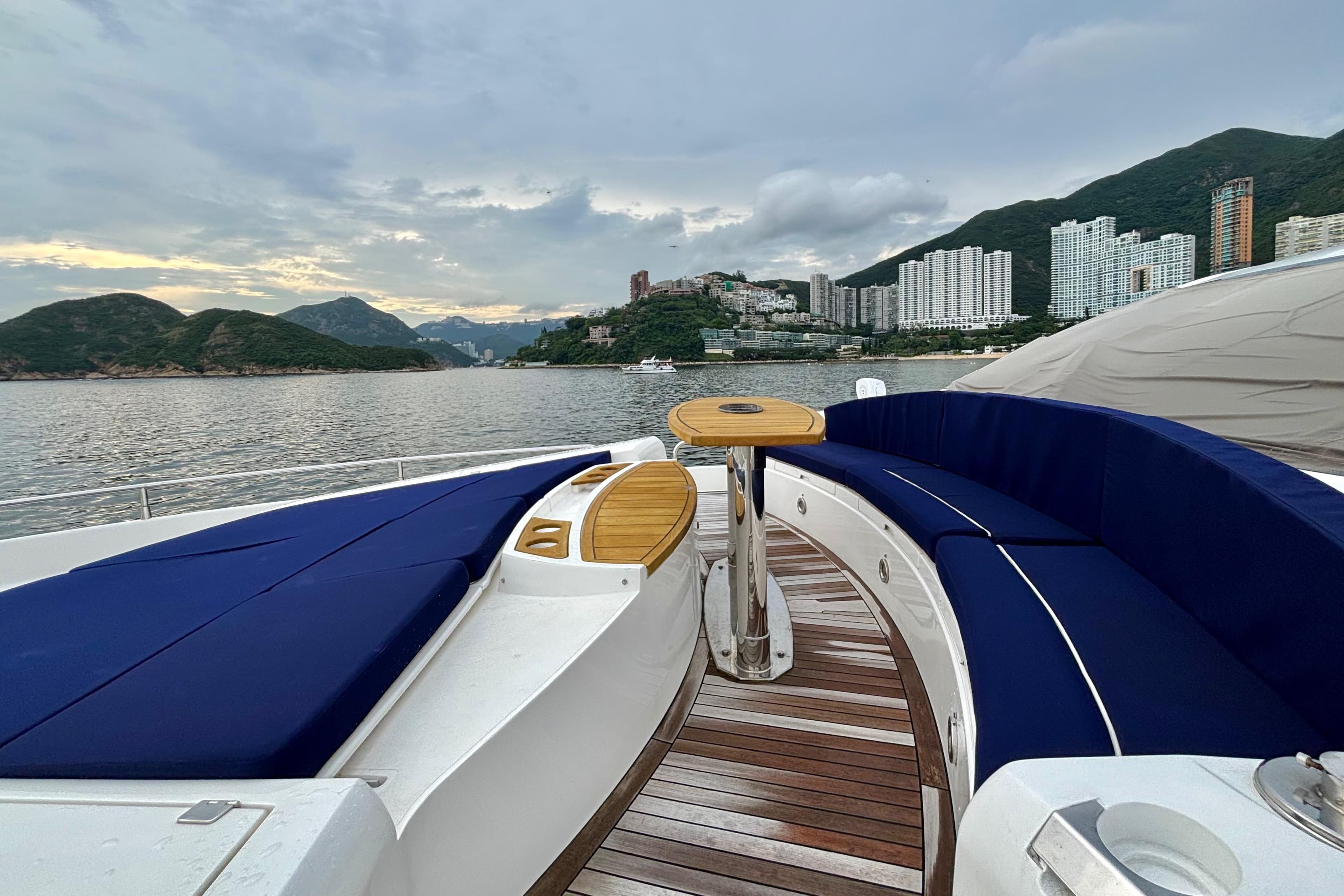 Luxurious 2011 Sunseeker 88 Yacht with elegant seating, scenic coastal backdrop.