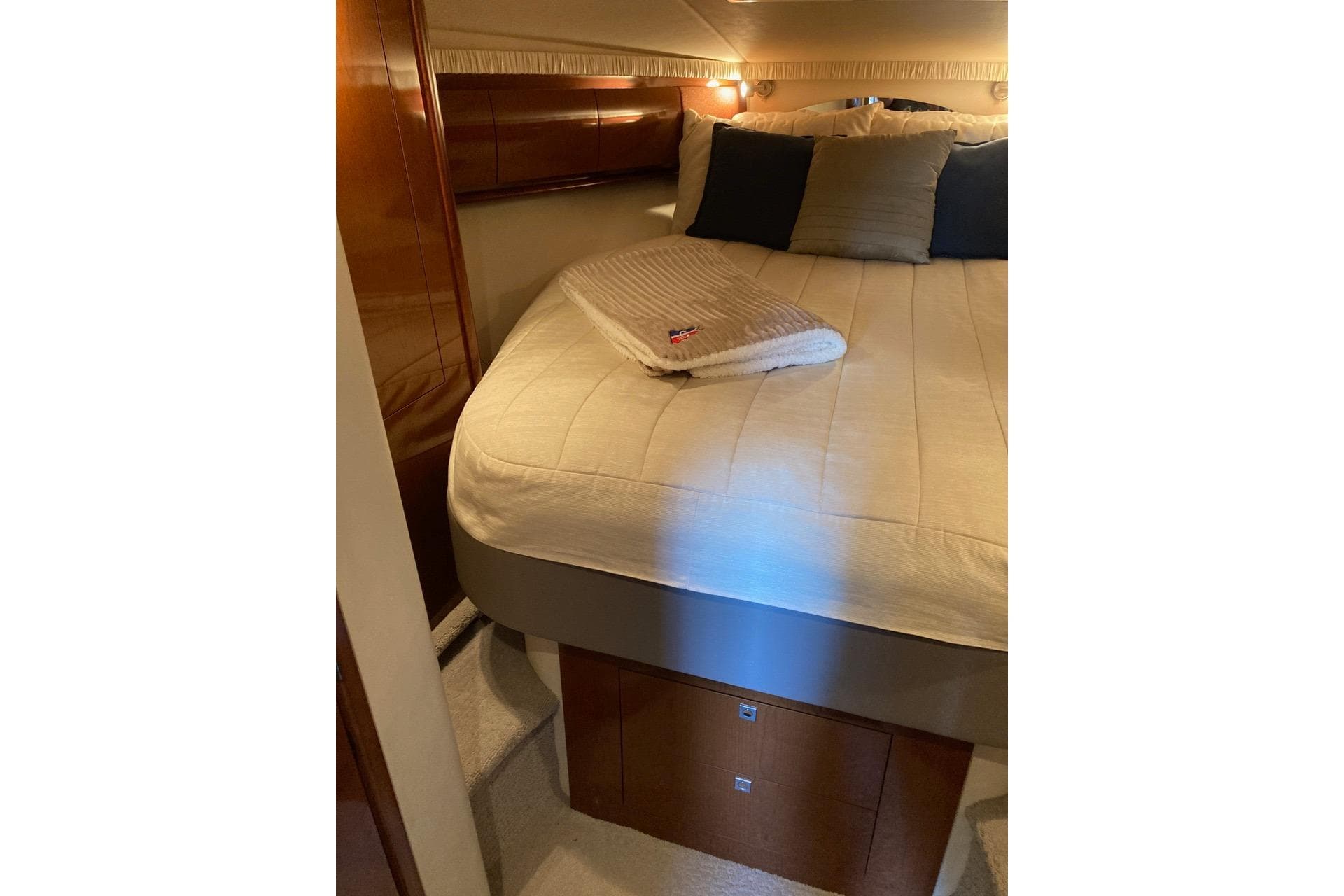 Luxurious cabin interior of 2008 Sea Ray 44 Sundancer yacht with cozy bedding.