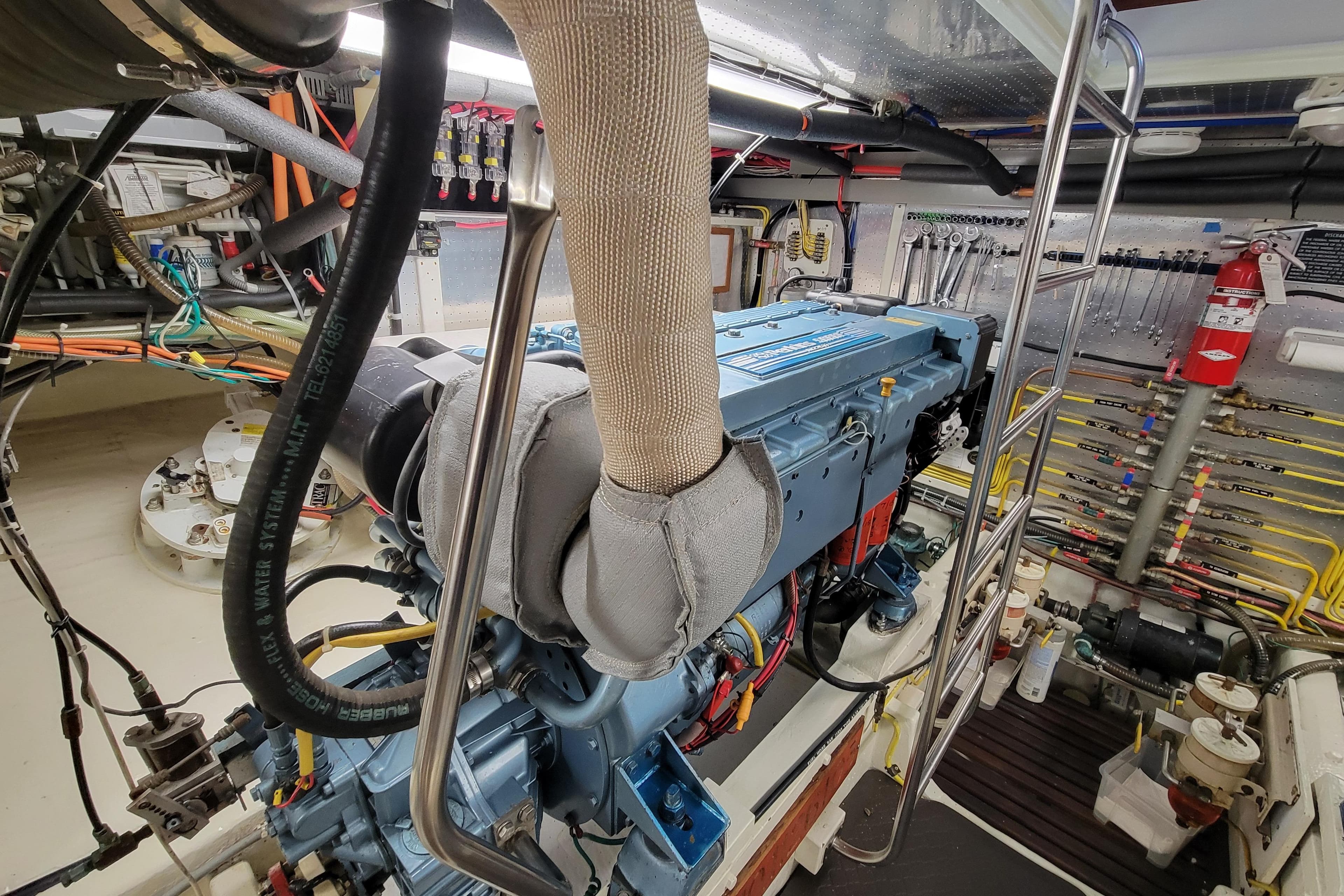 Engine room of a 2001 DeFever Pilothouse yacht, showcasing detailed machinery and equipment.
