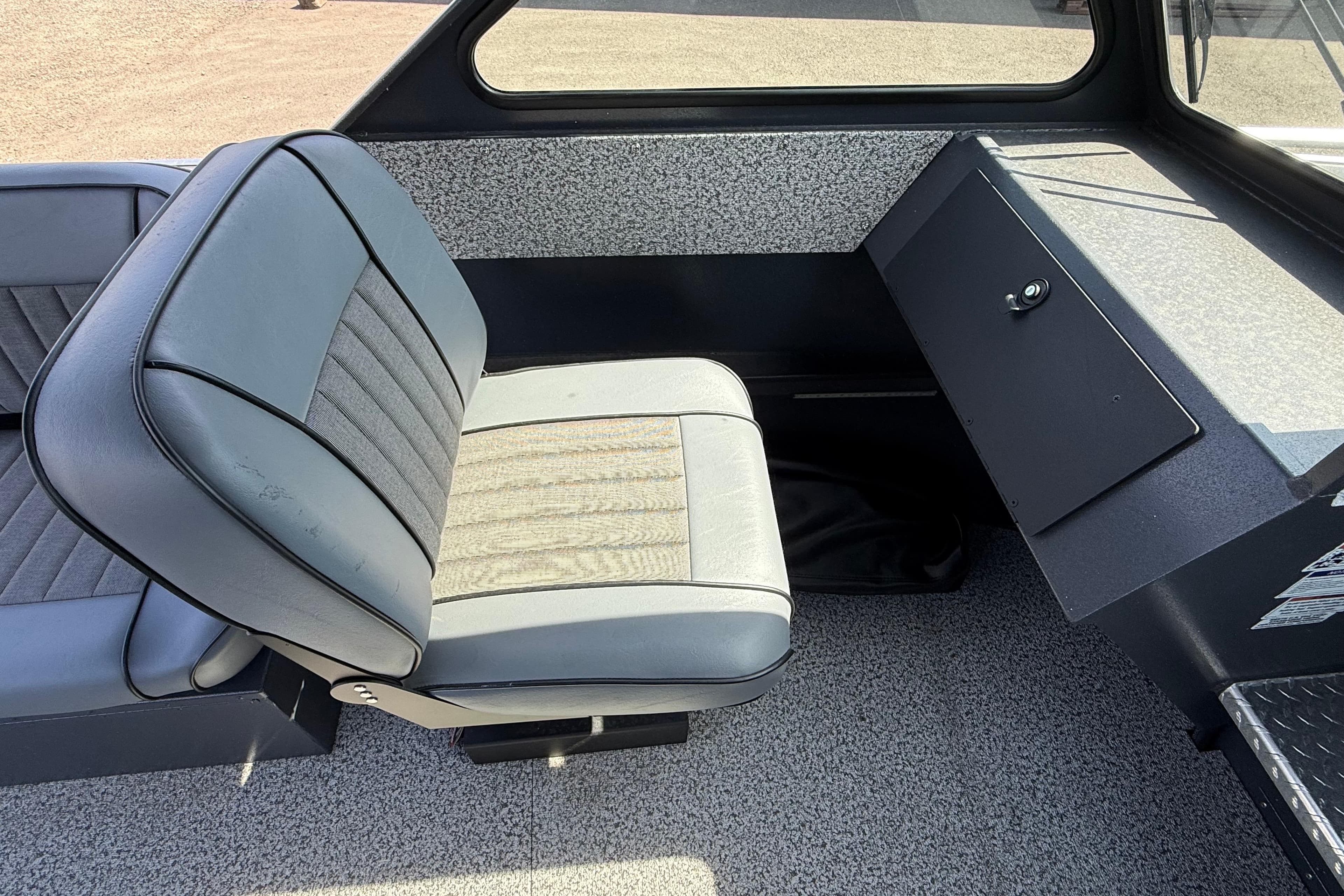 2026 Alumaweld Intruder 22 interior with gray seating and storage compartment.