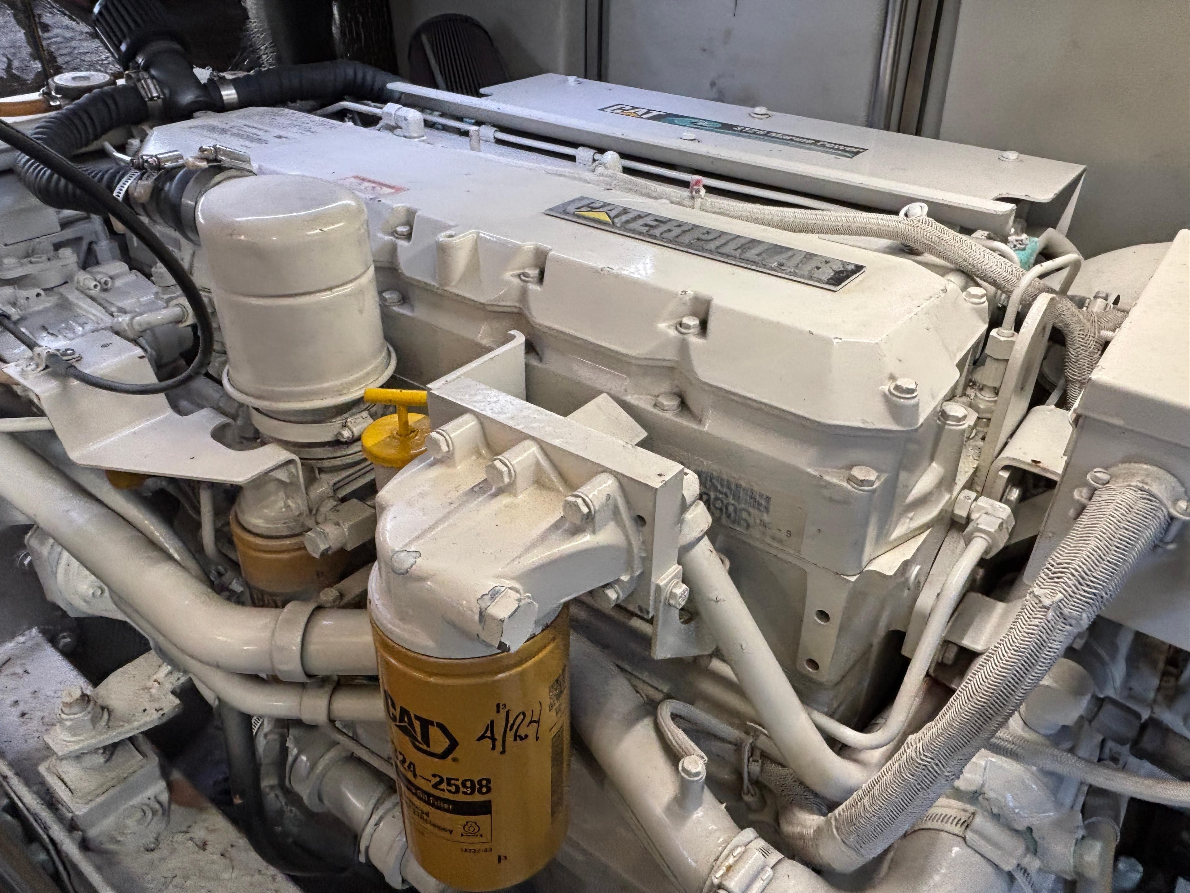 Engine of a 2001 Silverton 410 Sport Bridge yacht, featuring detailed components and filters.