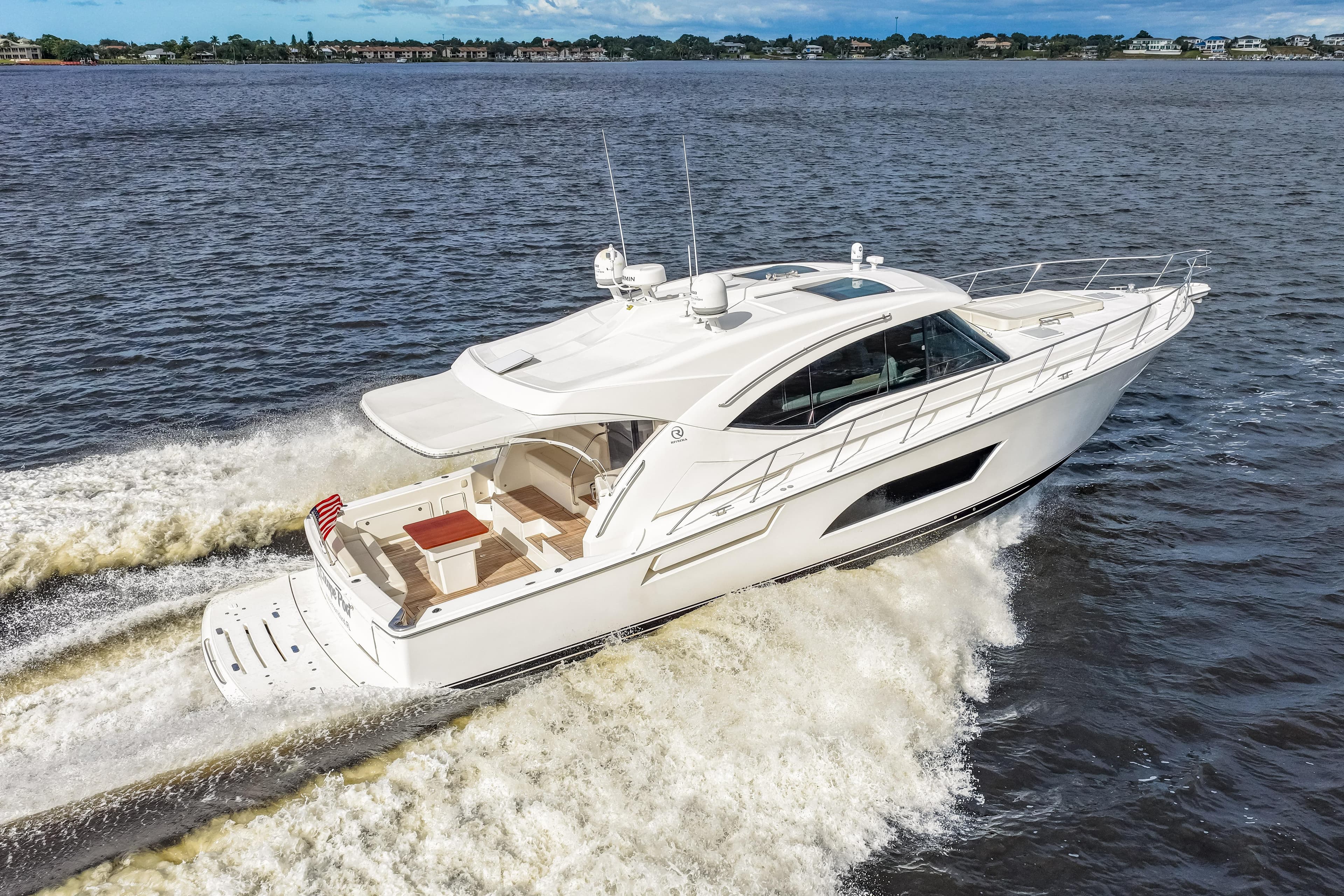 2015 Riviera 565 SUV yacht cruising on open water.