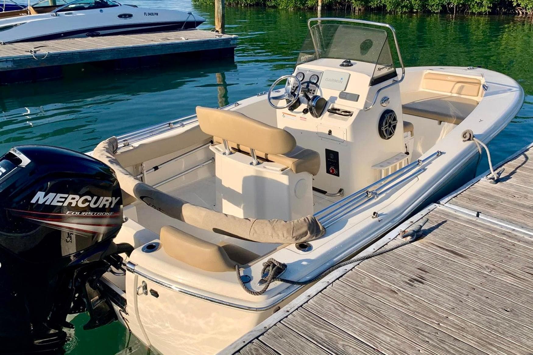 2019 Scout 195 Sportfish boat docked, featuring Mercury engine and Garmin navigation.