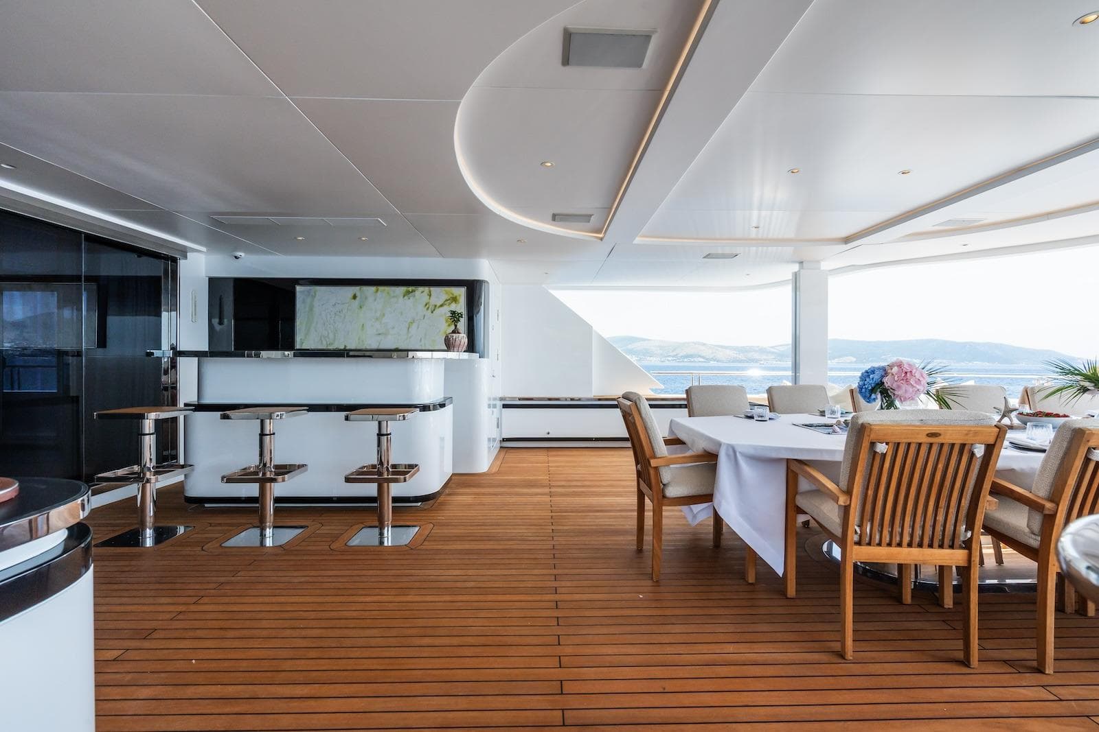 Luxurious 2022 CMB Yachts CMB 47 deck with elegant dining and bar area.