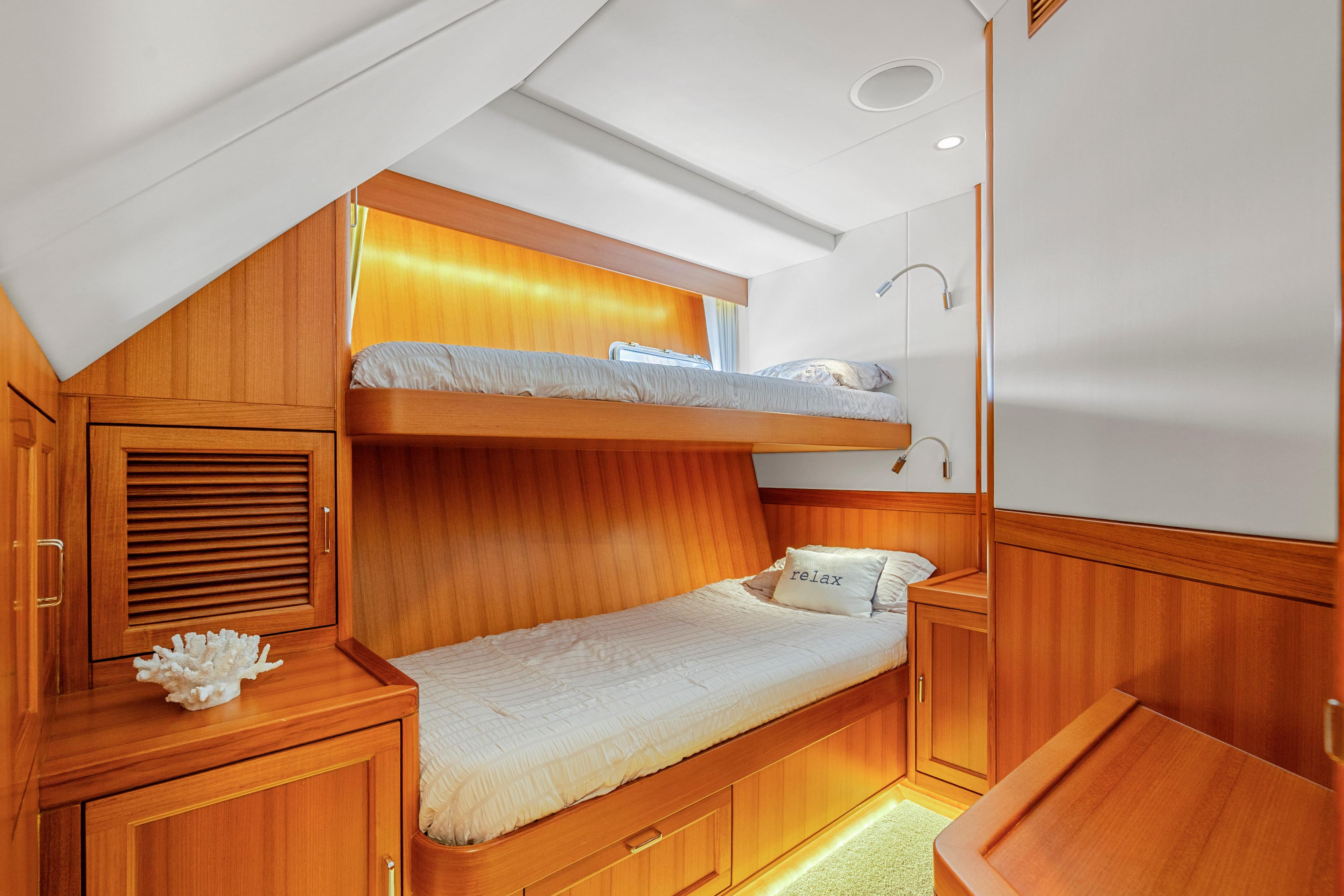 Luxurious wooden cabin with bunk beds in a 2023 Fleming 85 yacht.