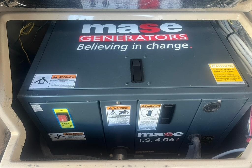 Mase generator in a 2013 Cutwater C-28 boat, featuring safety warnings and controls.