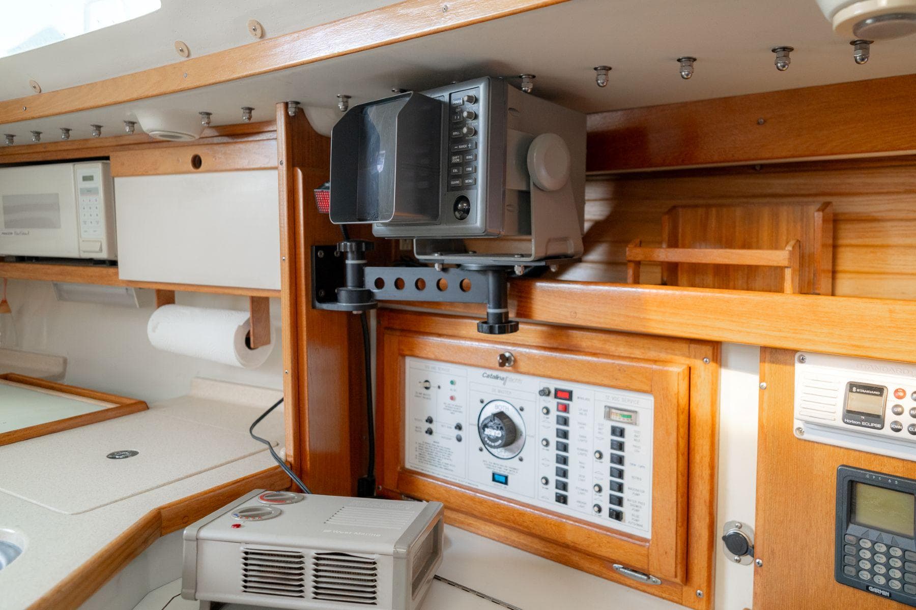 Interior of a 1994 Catalina 320 sailboat featuring navigation equipment and control panel.