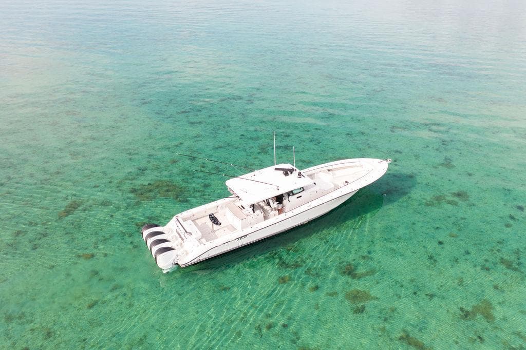 Aerial view of 2019 HCB 53 boat on clear turquoise water.