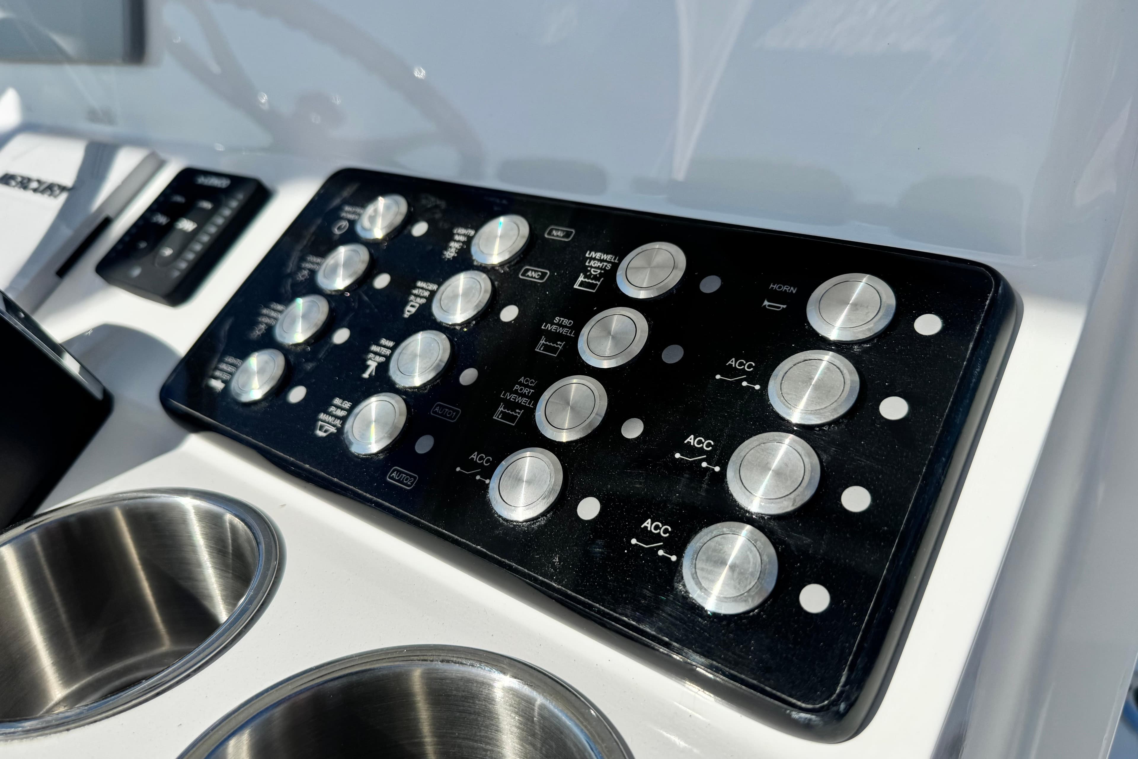 Control panel of 2026 Caymas 28 HB boat with buttons and cup holders.
