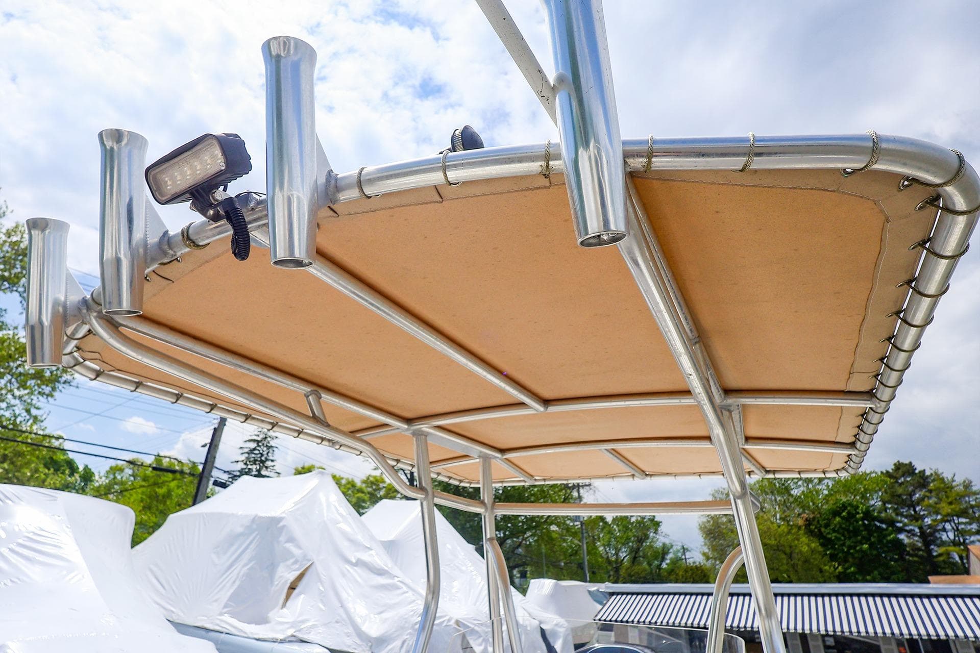 T-top of a 2016 Release 208 RX boat with rod holders and mounted light.