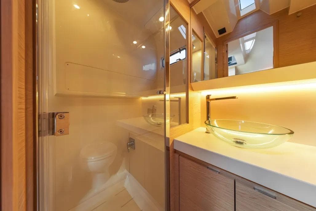 Luxurious bathroom interior of 2024 Solaris Power 44 Open yacht with glass sink and modern fixtures.