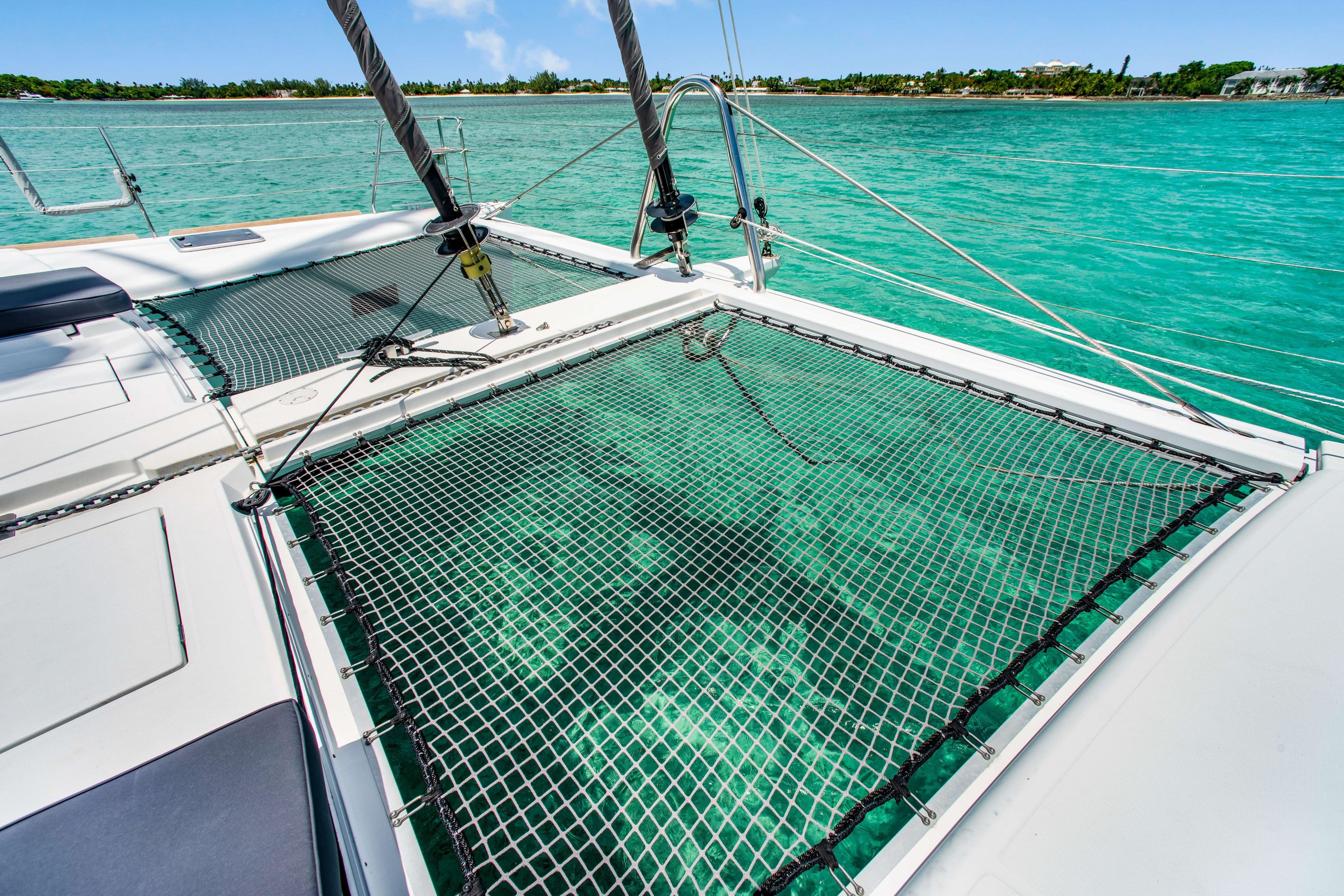 Lagoon 560 catamaran, 2014 model, with netting over turquoise water.