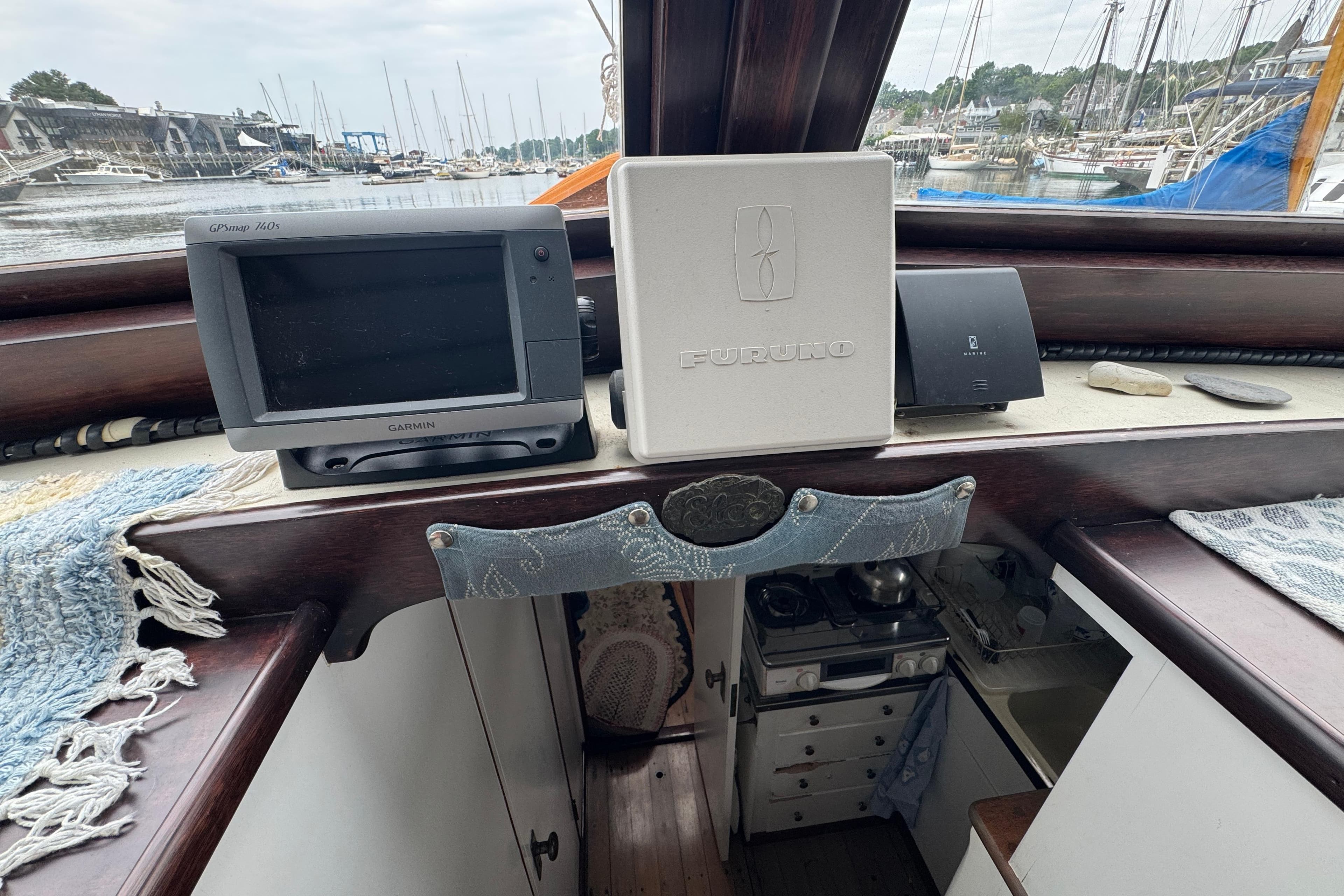 1940 Elco Cruisette interior with navigation equipment and marina view.
