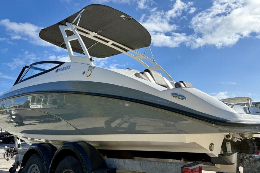 2020 Yamaha Boats AR210 on trailer under clear blue sky.