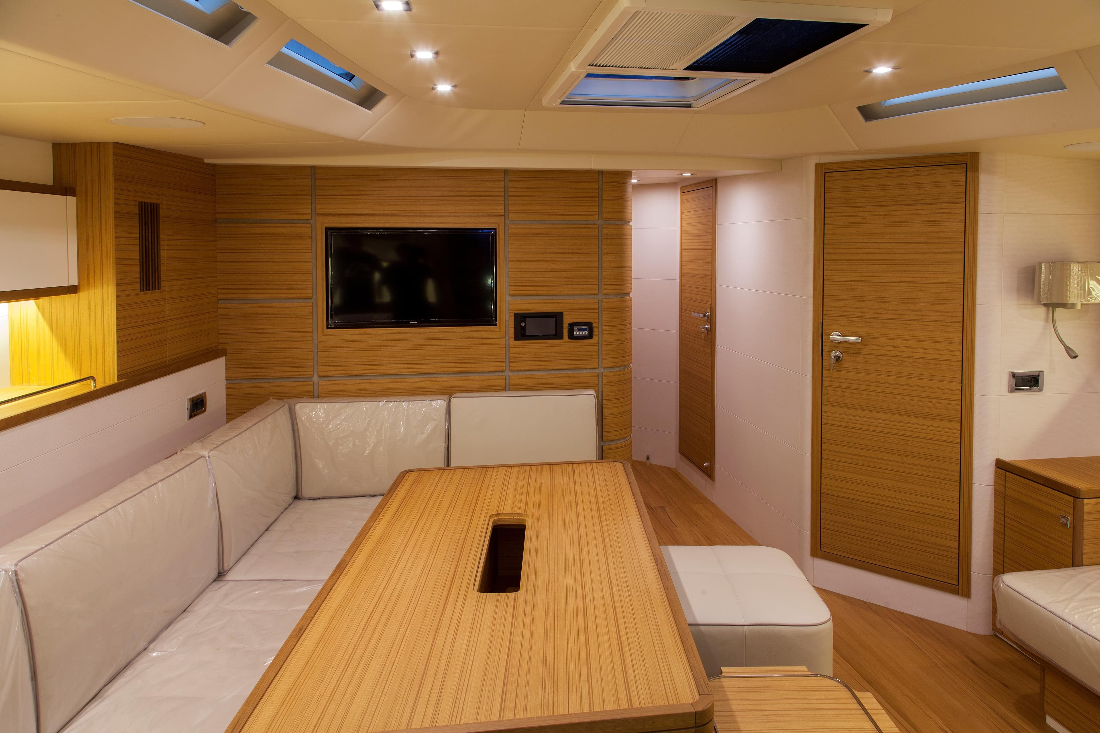 Luxurious interior of 2026 Mazarin 72 Cruiser/Racer, featuring modern wood finishes and sleek design.