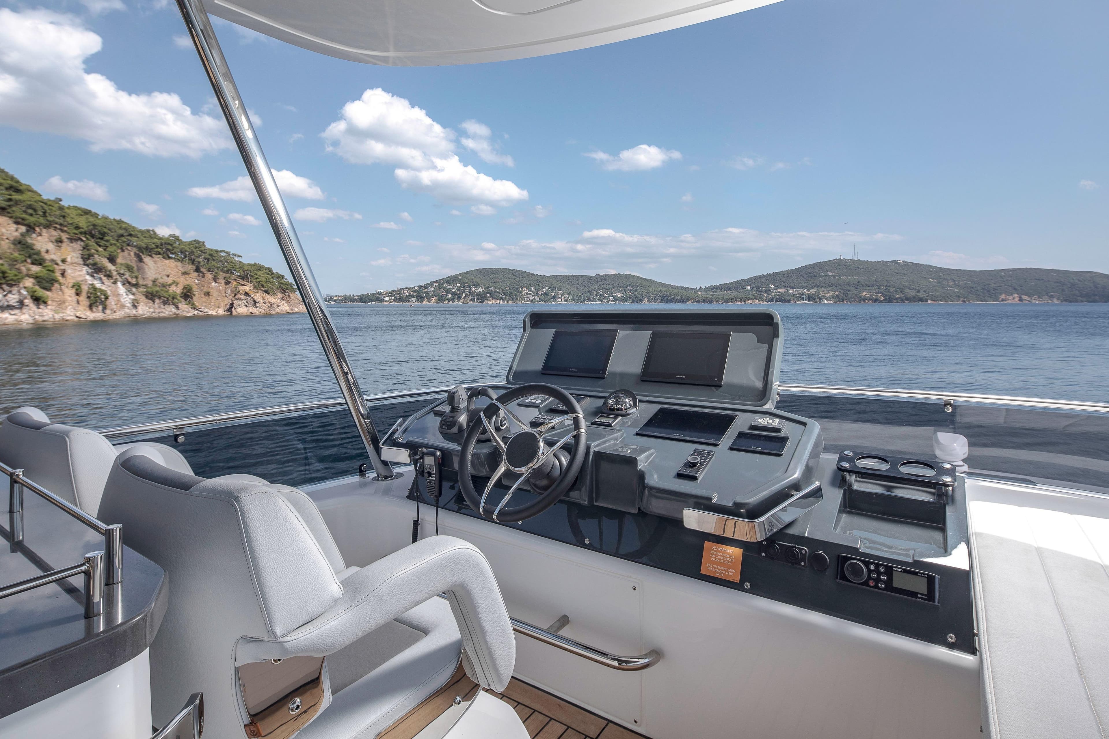 Helm of 2026 Sirena 60 yacht with scenic ocean view and modern controls.