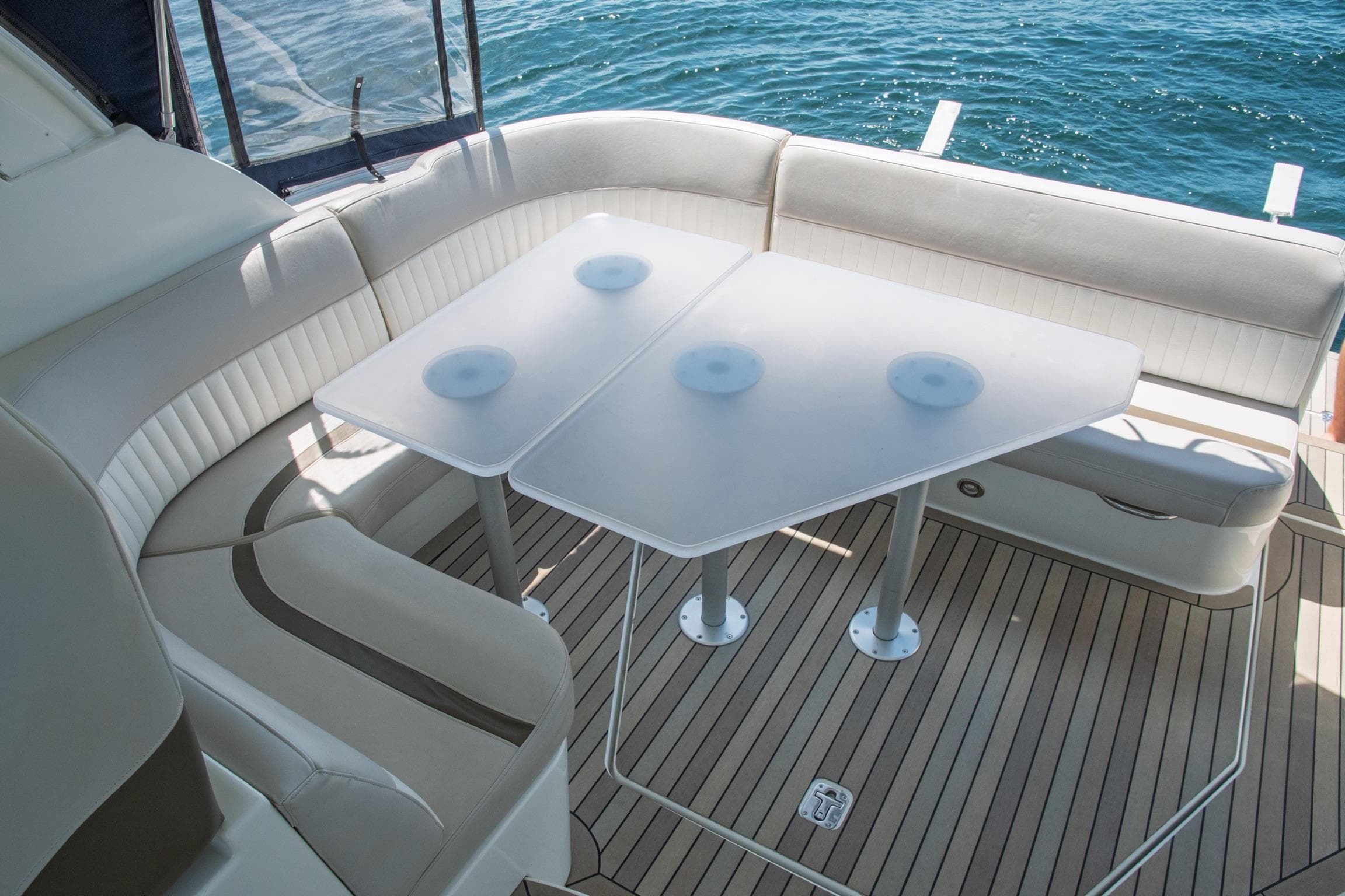 2011 Cruisers Yachts 420 Sport Coupe interior with elegant seating and table, overlooking the water.