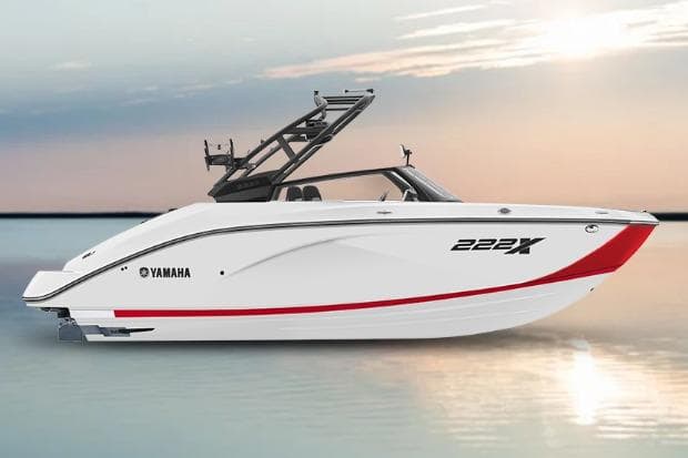 2026 Yamaha Boats 222XD, sleek white design, red accent, on calm water at sunset.