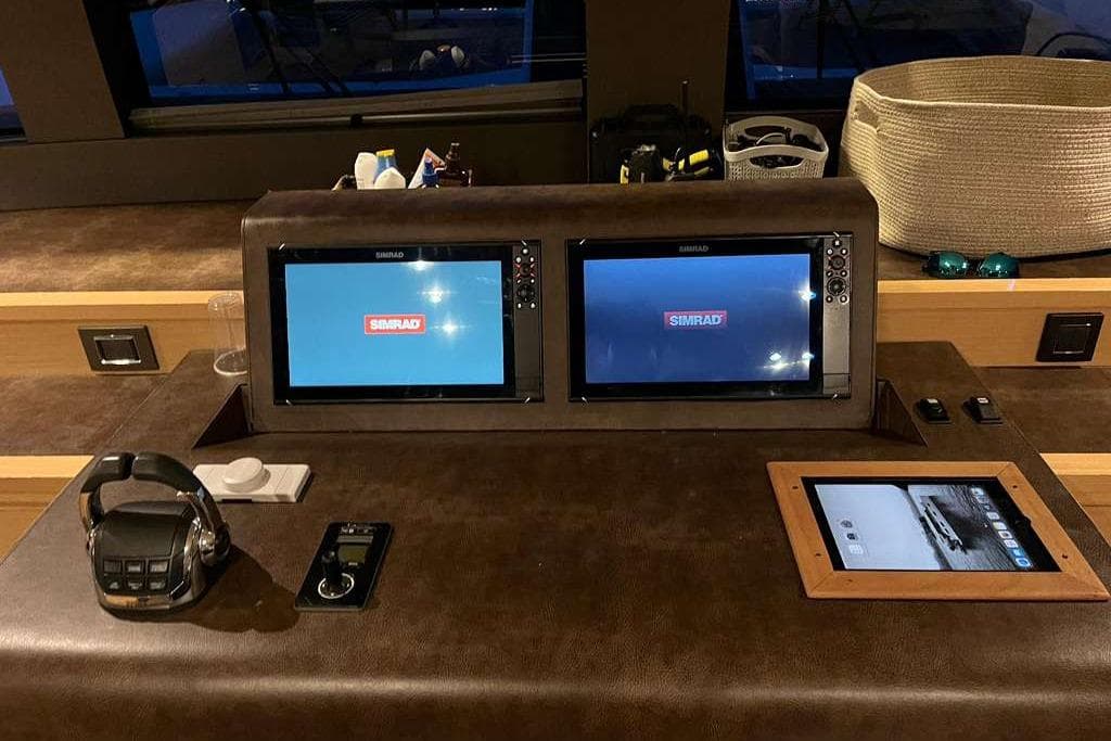 Control panel of 2019 Lagoon 630 MY yacht with Simrad displays and navigation equipment.