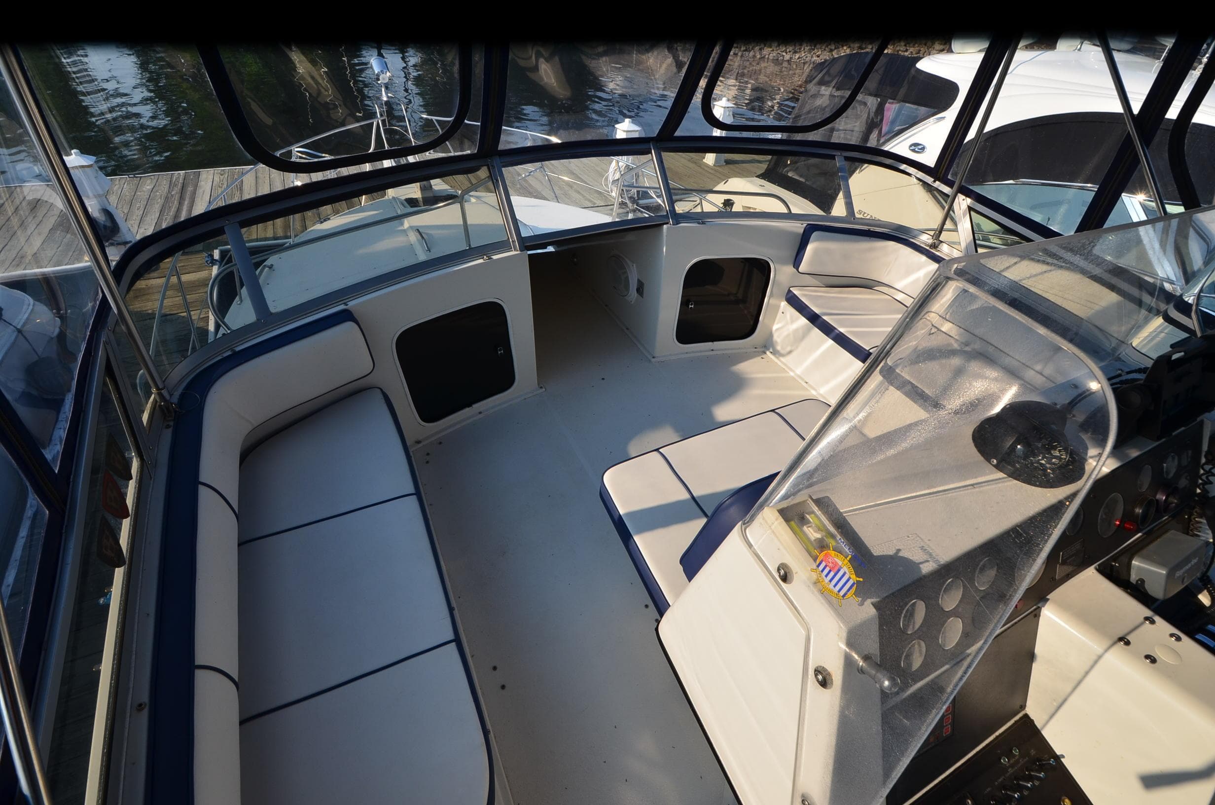 1989 Carver SANTEGO boat interior with seating and control panel, docked at marina.