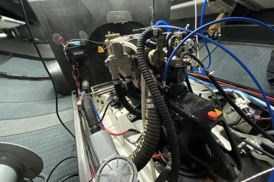 Engine compartment of 2023 Carkeek 45 yacht, showcasing intricate wiring and components.