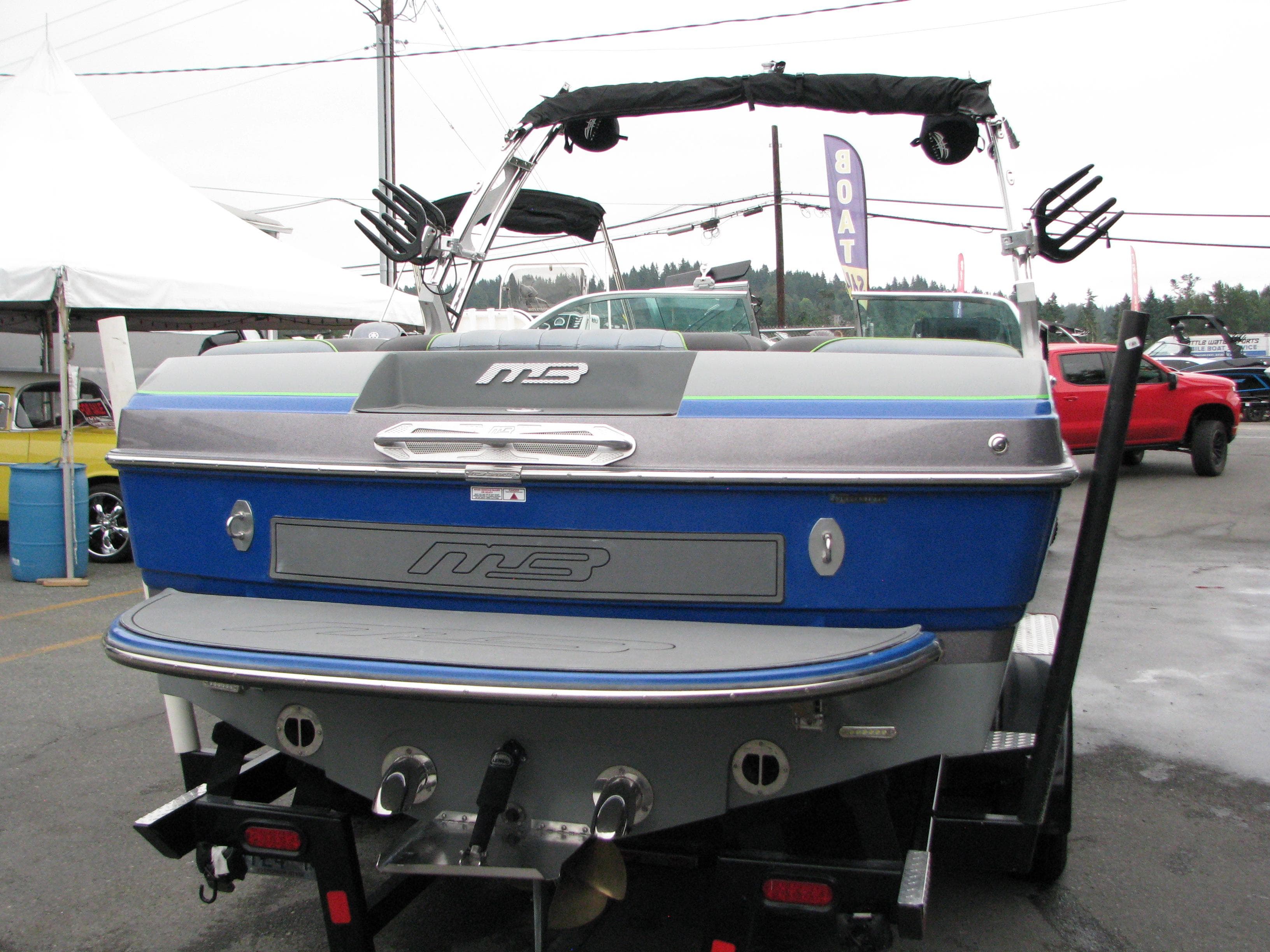 2014 MB B-52 23 Widebody boat, blue and silver, displayed outdoors on a trailer.