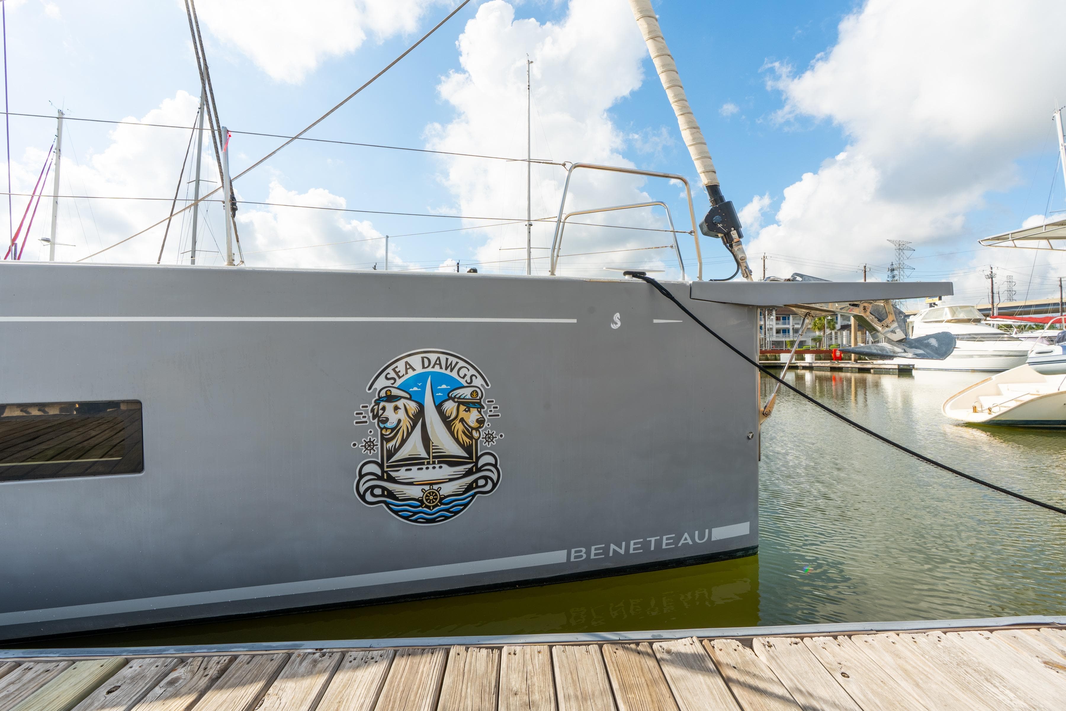 Beneteau Oceanis Yacht 54, 2021 model, docked with "Sea Dawgs" emblem.