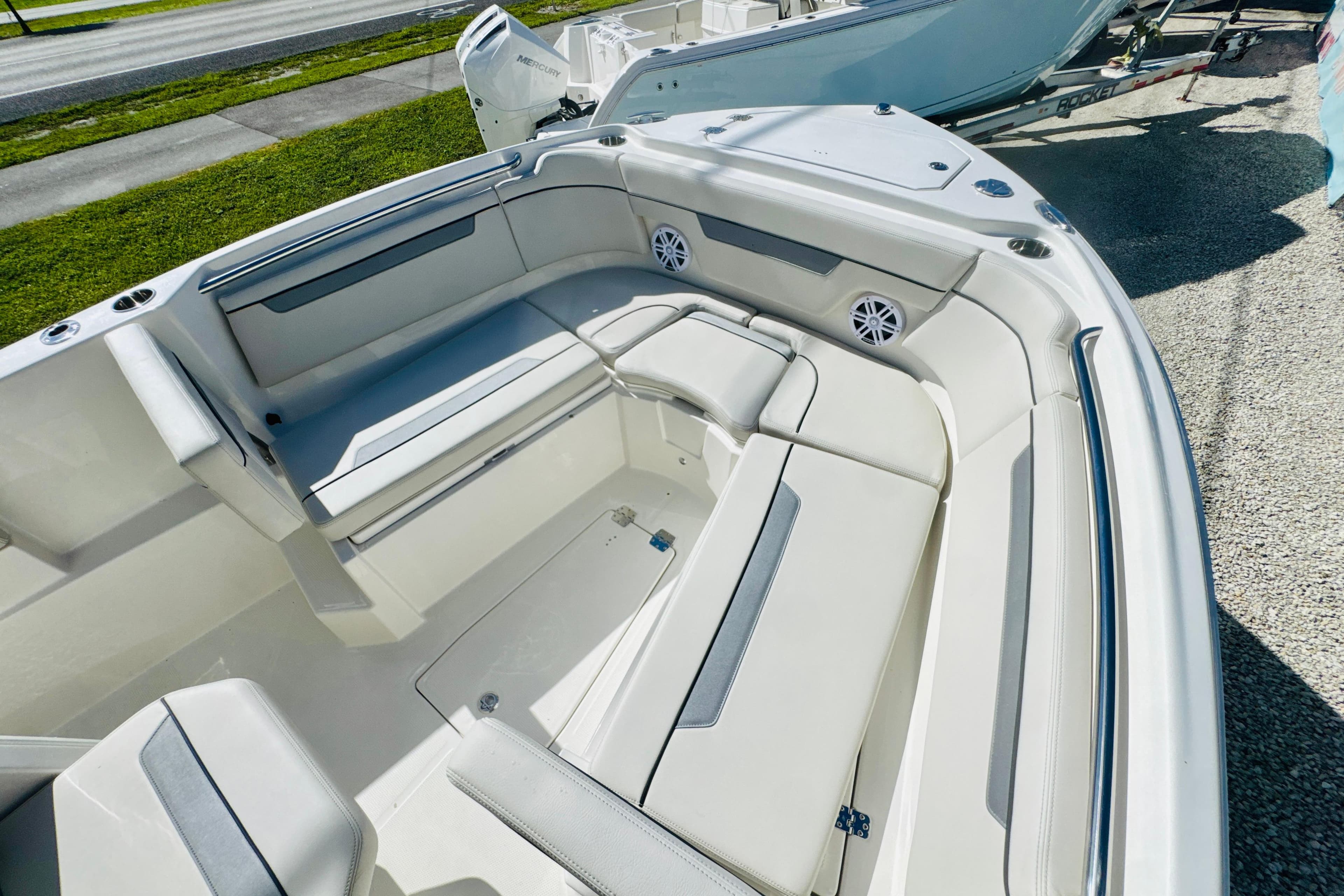 2026 Sailfish 252 CC boat interior with cushioned seating and speakers.