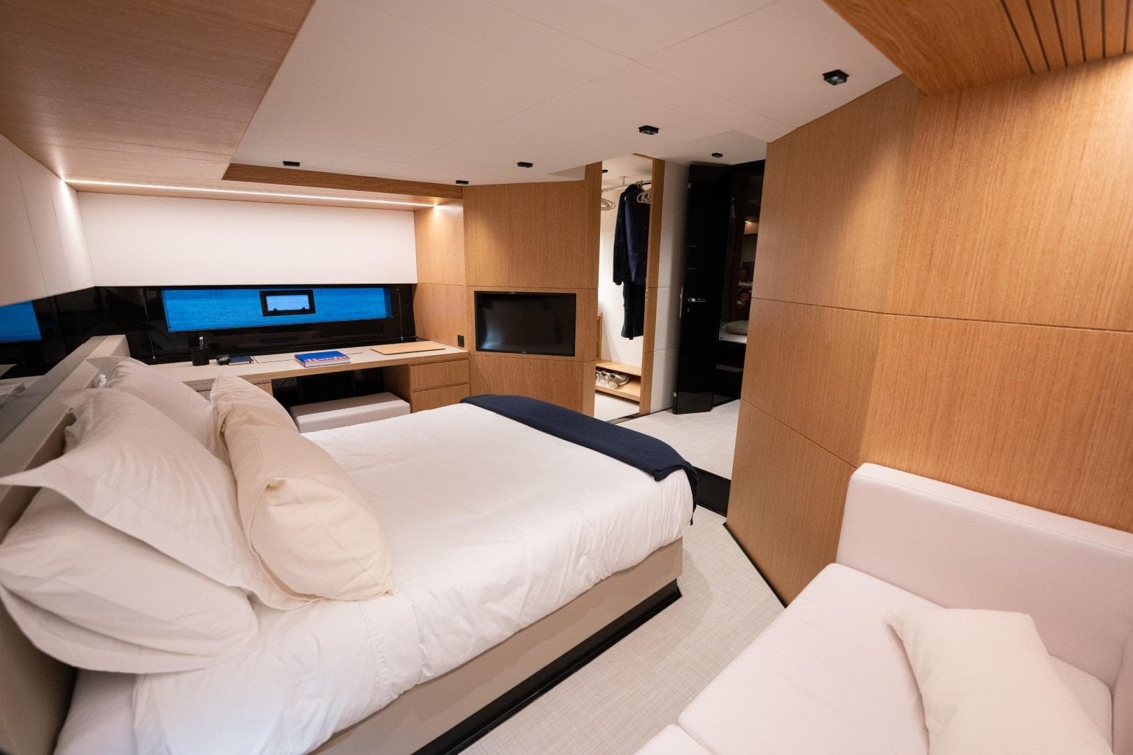 Luxurious interior of 2026 De Antonio Yachts D60, featuring a cozy bedroom with modern design.