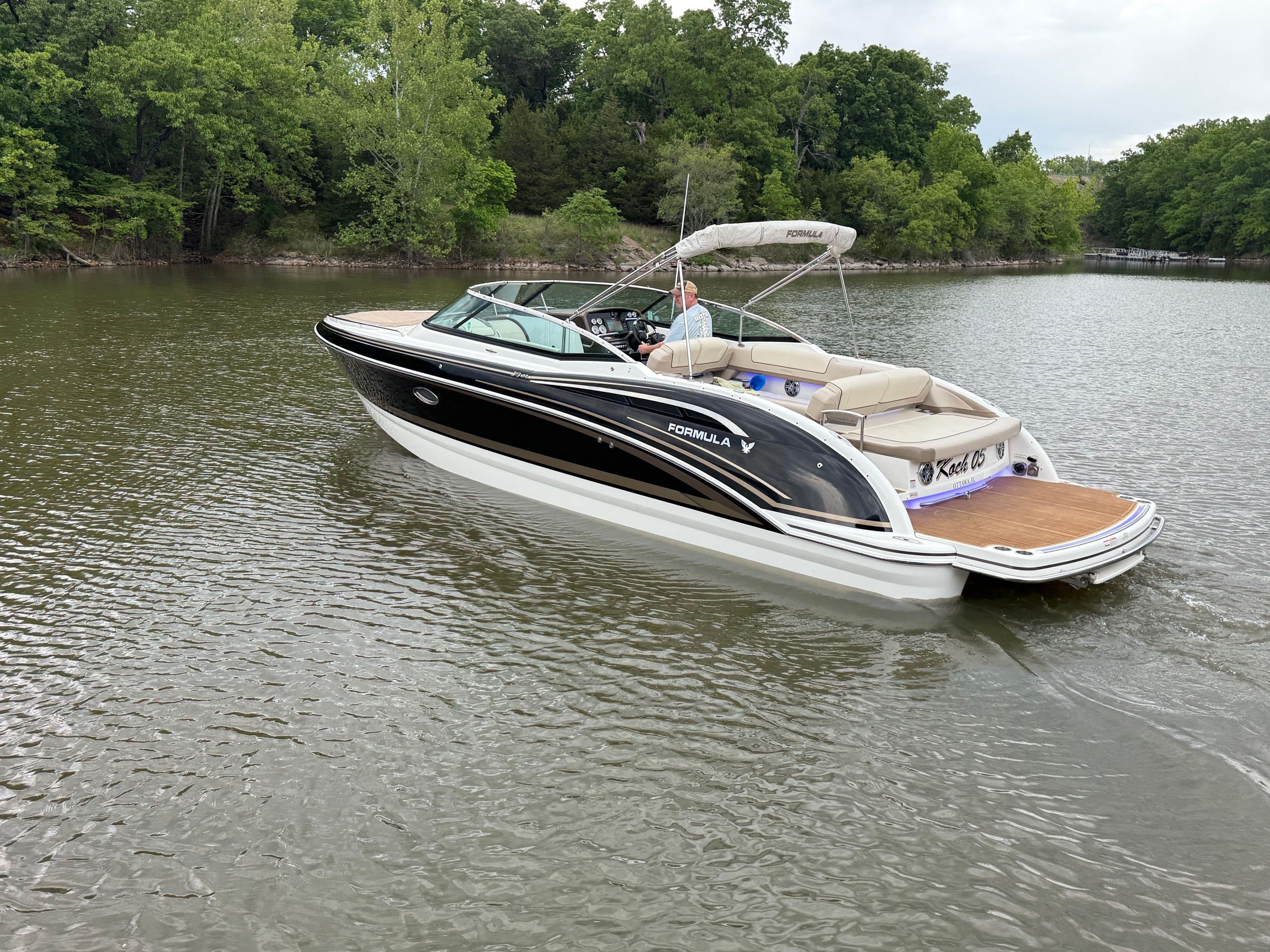 2016 Formula 310 BR boat on a calm lake.