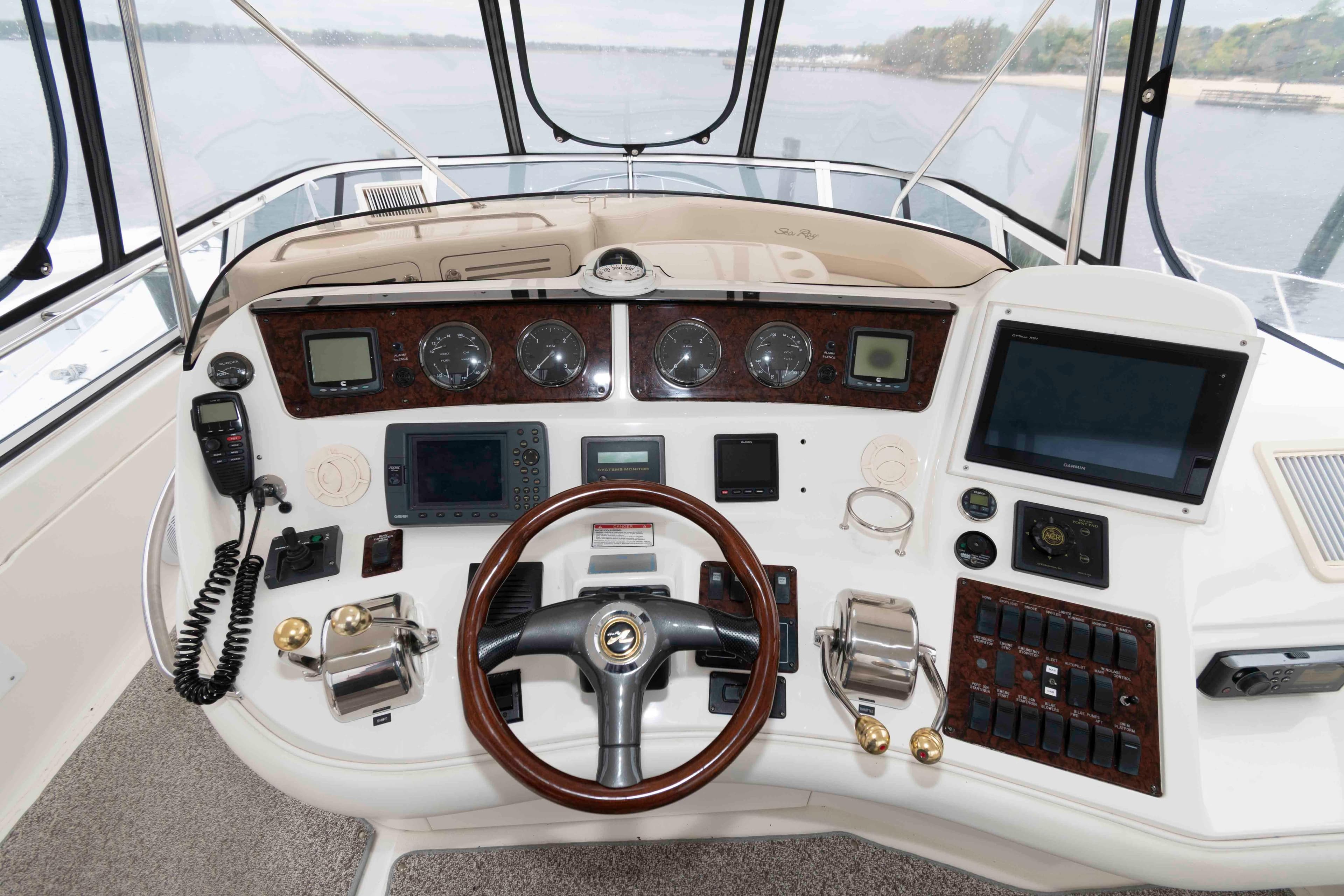 Helm of 2003 Sea Ray 480 Sedan Bridge with navigation instruments and controls.