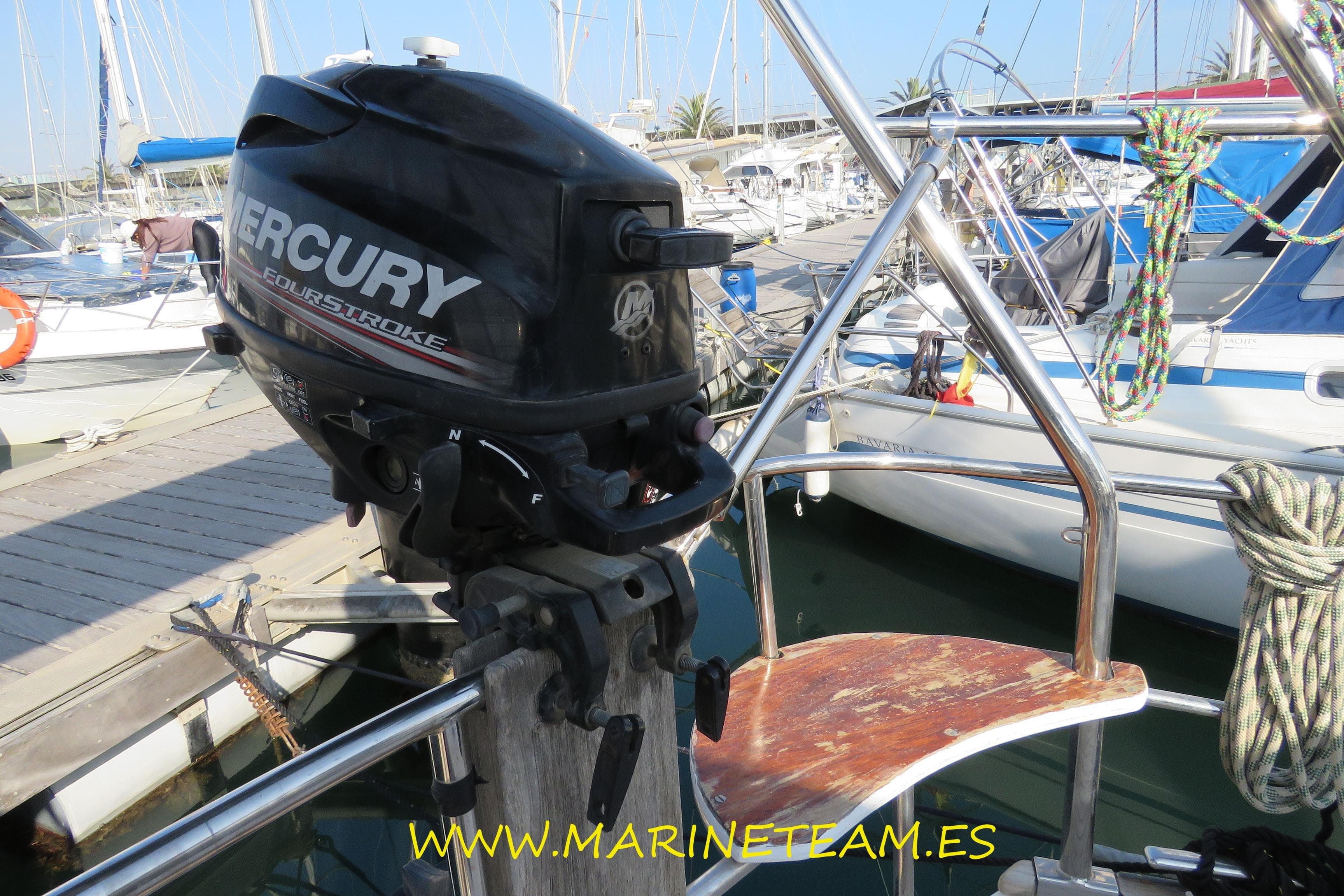 Outboard motor on Najad 373 sailboat, 2002 model, docked at marina with ropes and railings.