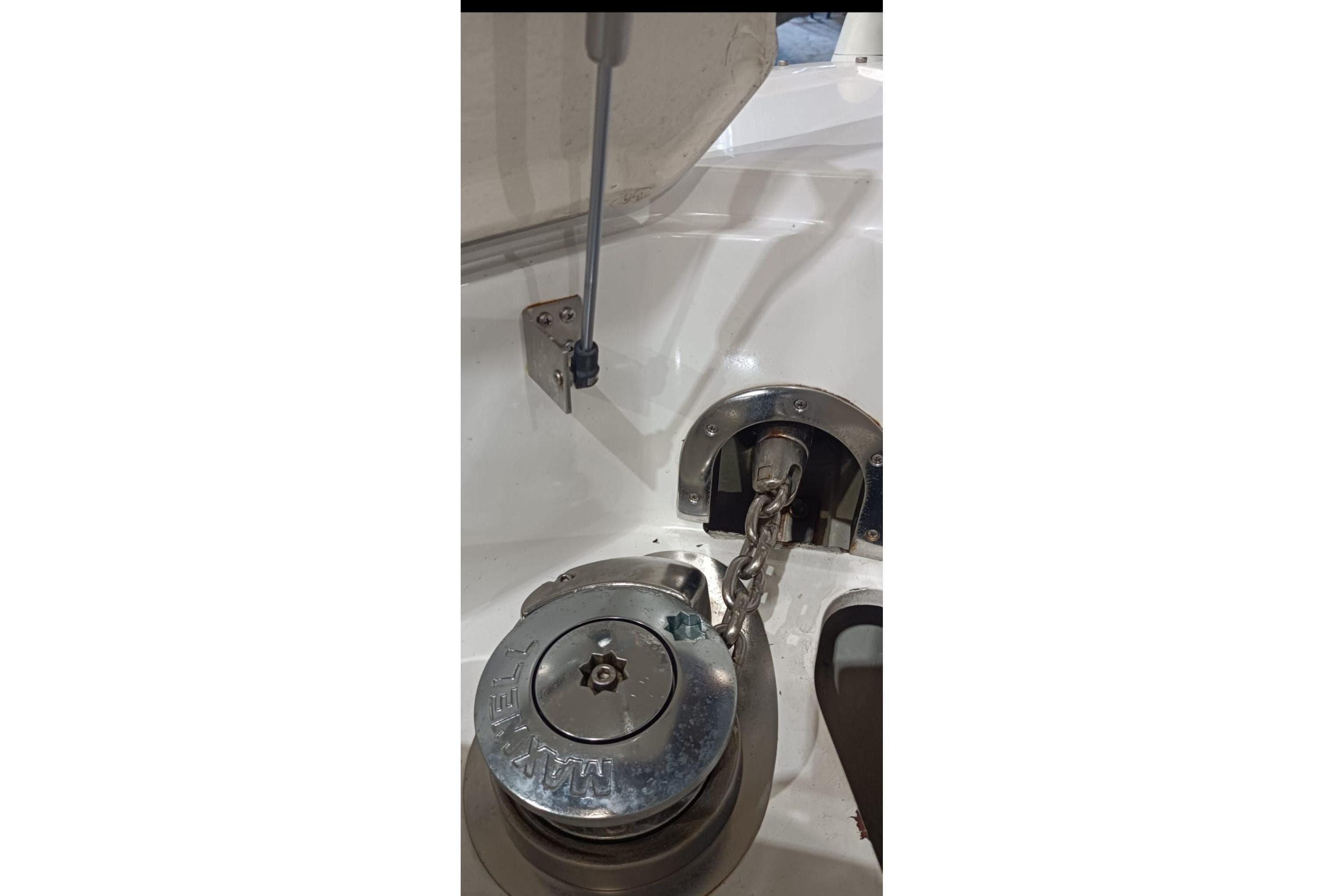Anchor windlass system on a 2011 Cobalt 296 boat, featuring a chain mechanism.