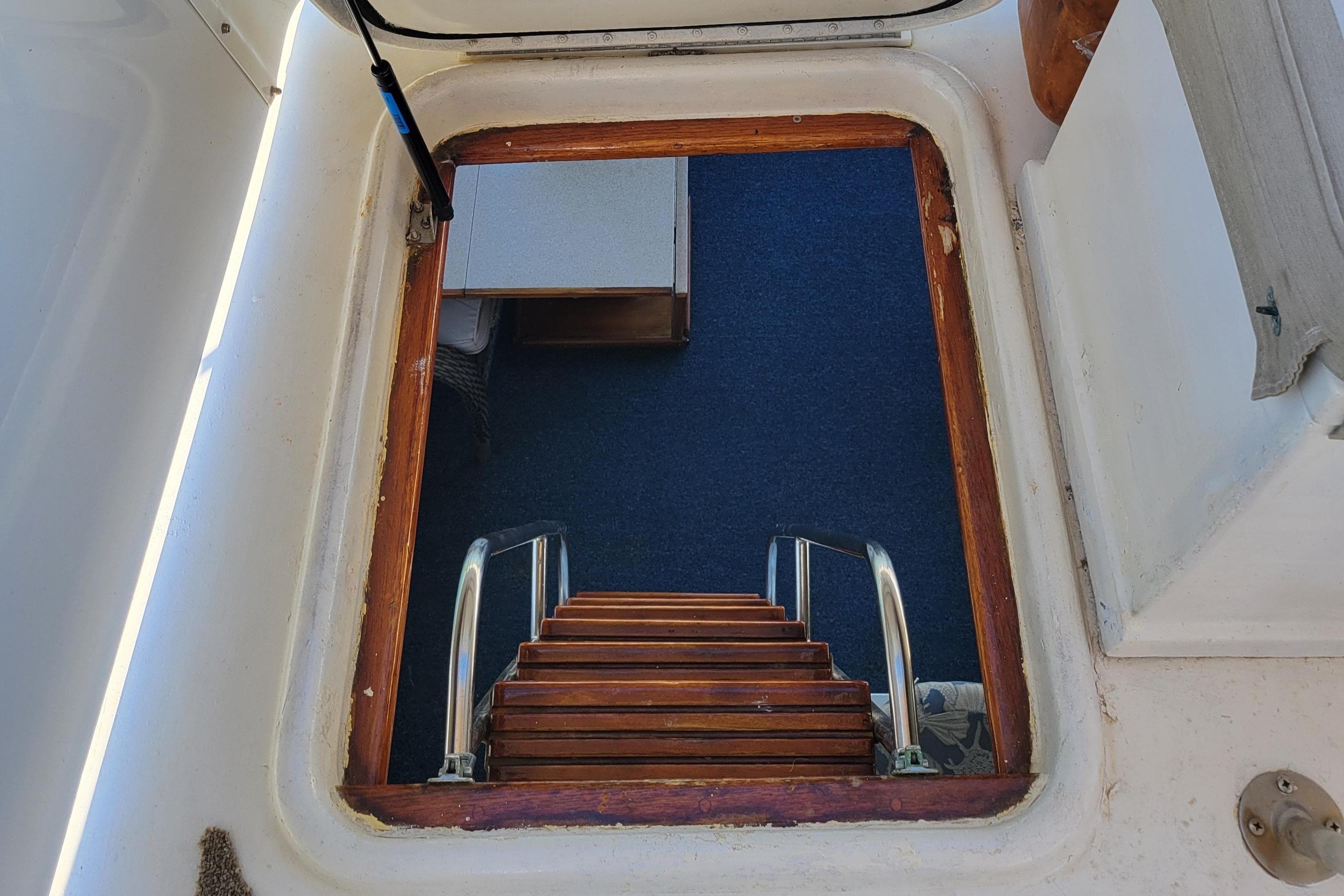 Stairway leading below deck on 1982 Hatteras 56 Wide Body yacht.