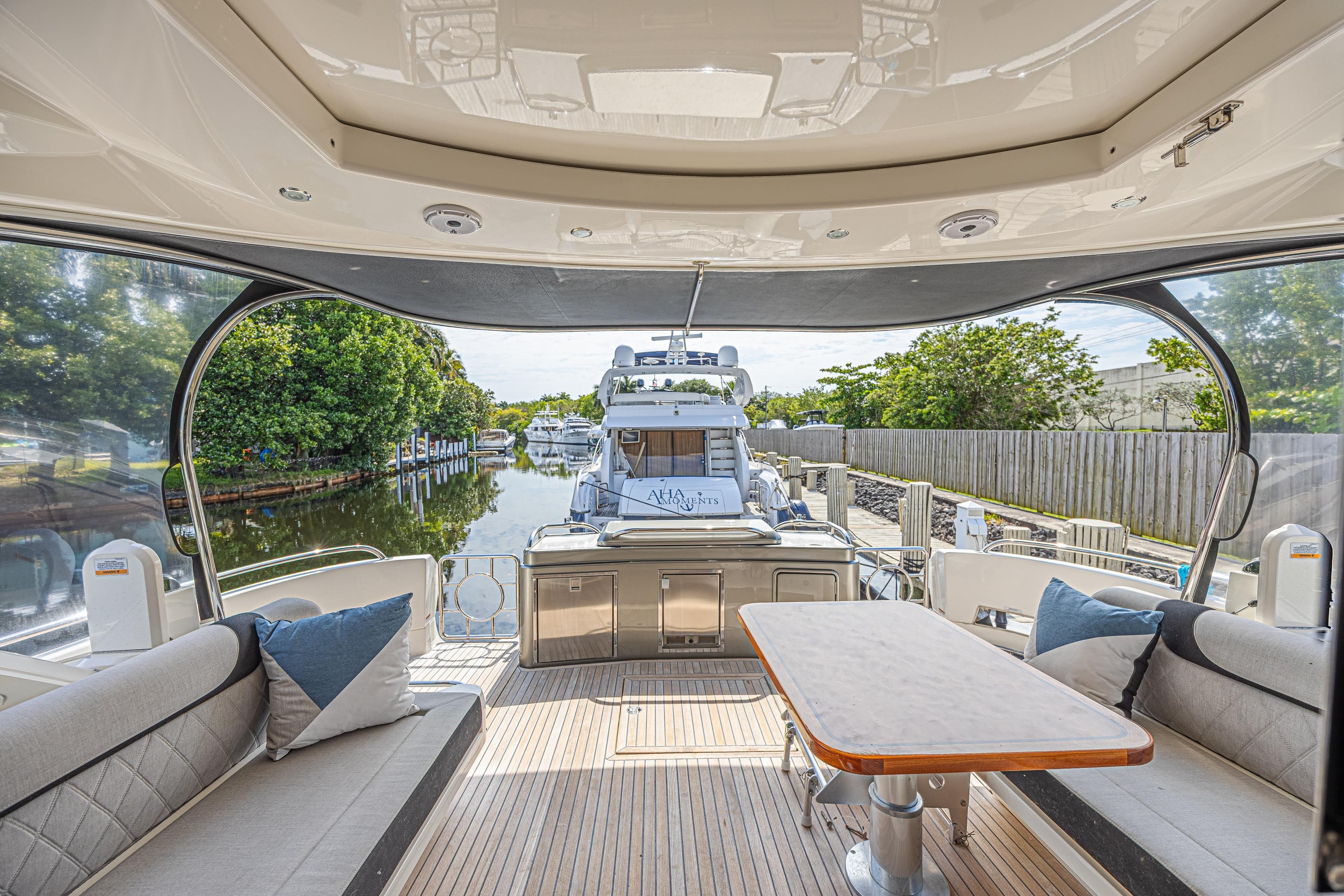 Luxurious 2021 Riviera 6000 Sport Yacht Platinum Edition interior with scenic marina view.