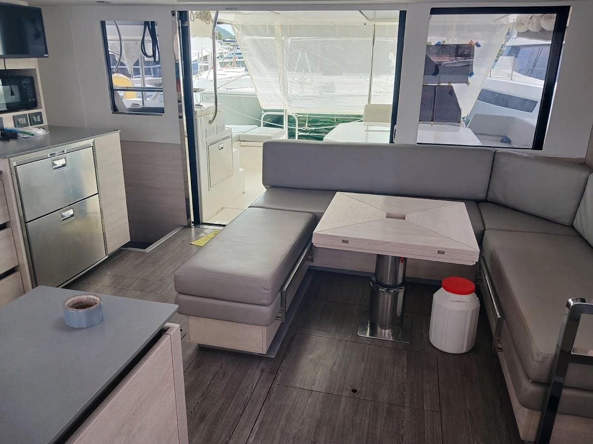 Modern interior of 2020 Leopard 50 yacht with sleek seating and dining area.